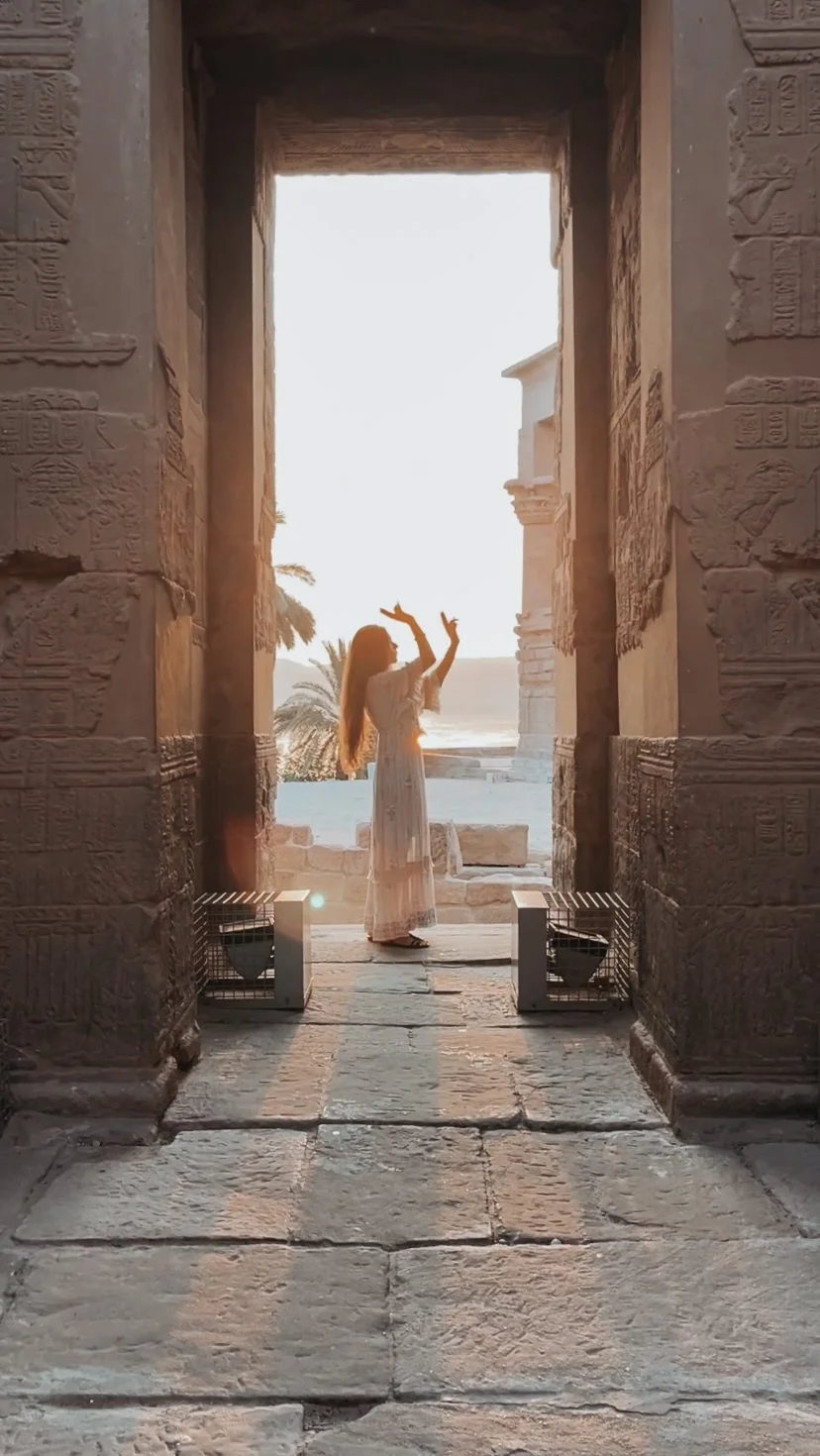 Divine feminine embodiment during a sunrise temple activation experience at Philae temple in Egypt.