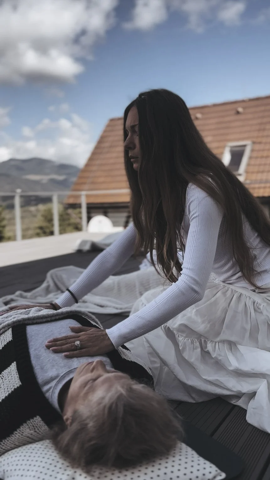 Sabina offering hands-on energy work during a Magdalene Codes Activation session — a moment of deep presence and womb-centered healing under the open sky.