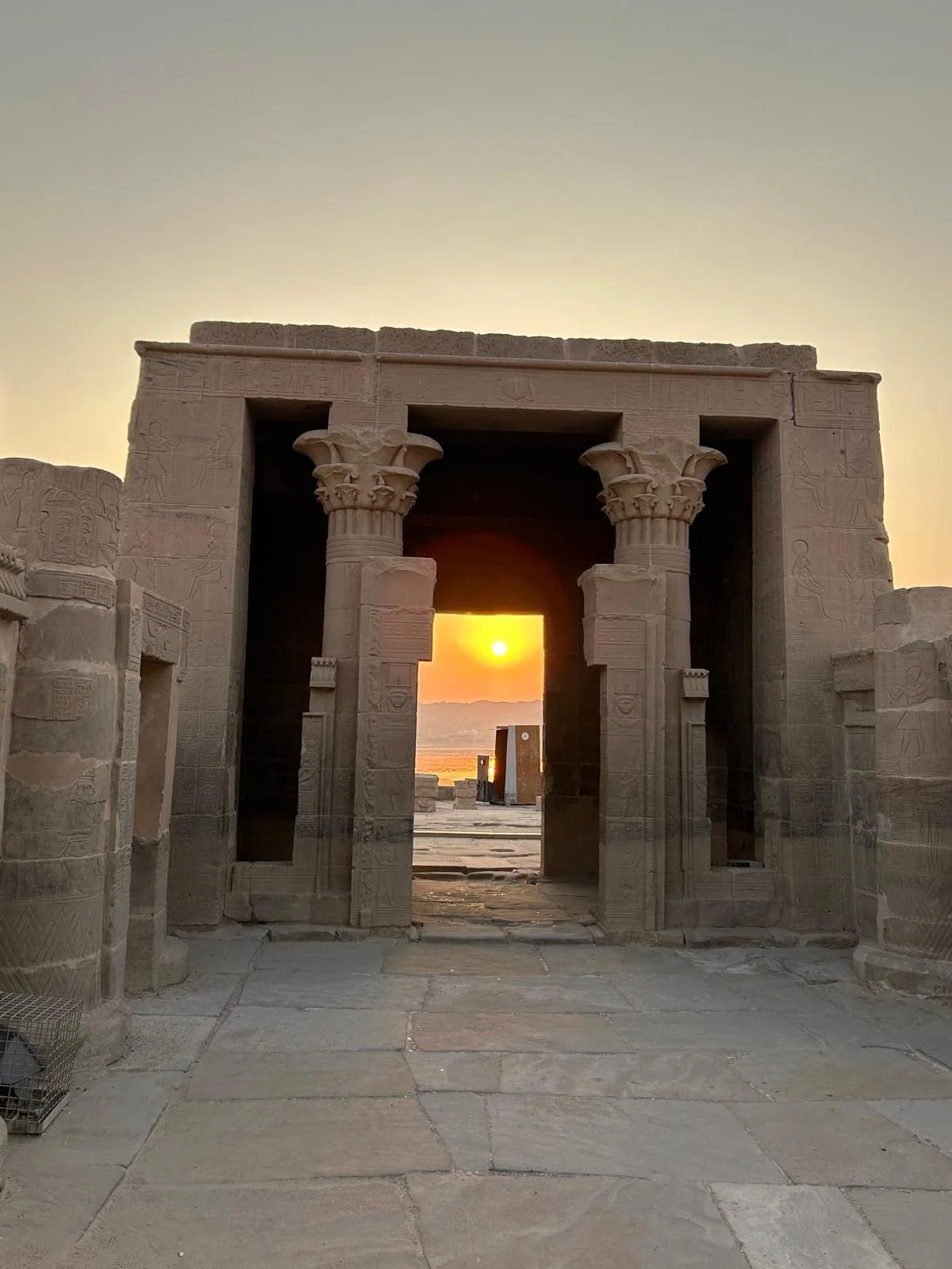 Ancient Egyptian Philae temple doorway aligned with the rising sun during a sacred pilgrimage journey.