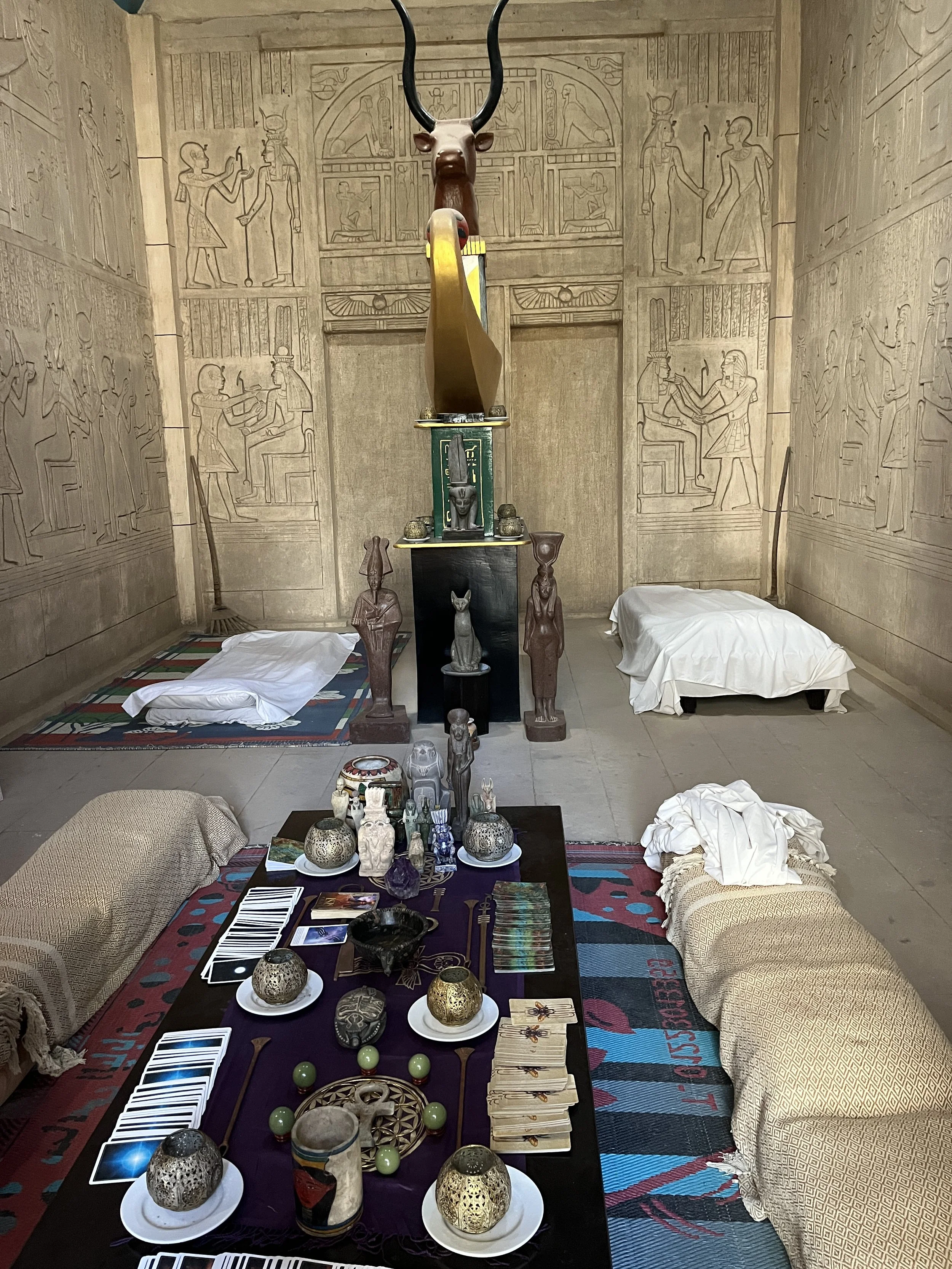 Sacred ceremony room interior at House of Life Abydos with Egyptian altar, deity statues and session mats for energy healing retreat