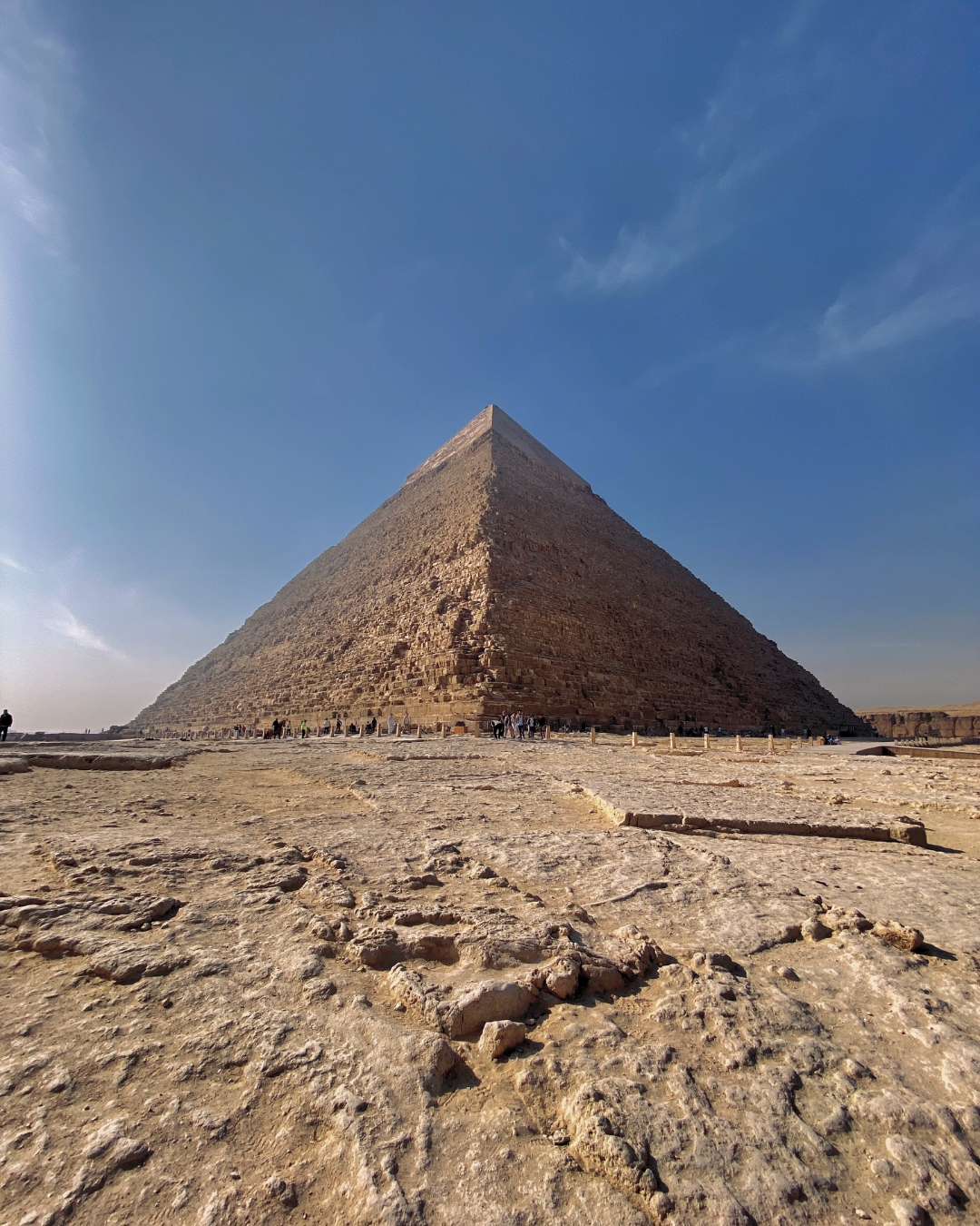 The Great Pyramid of Giza rising from the desert landscape in Egypt.