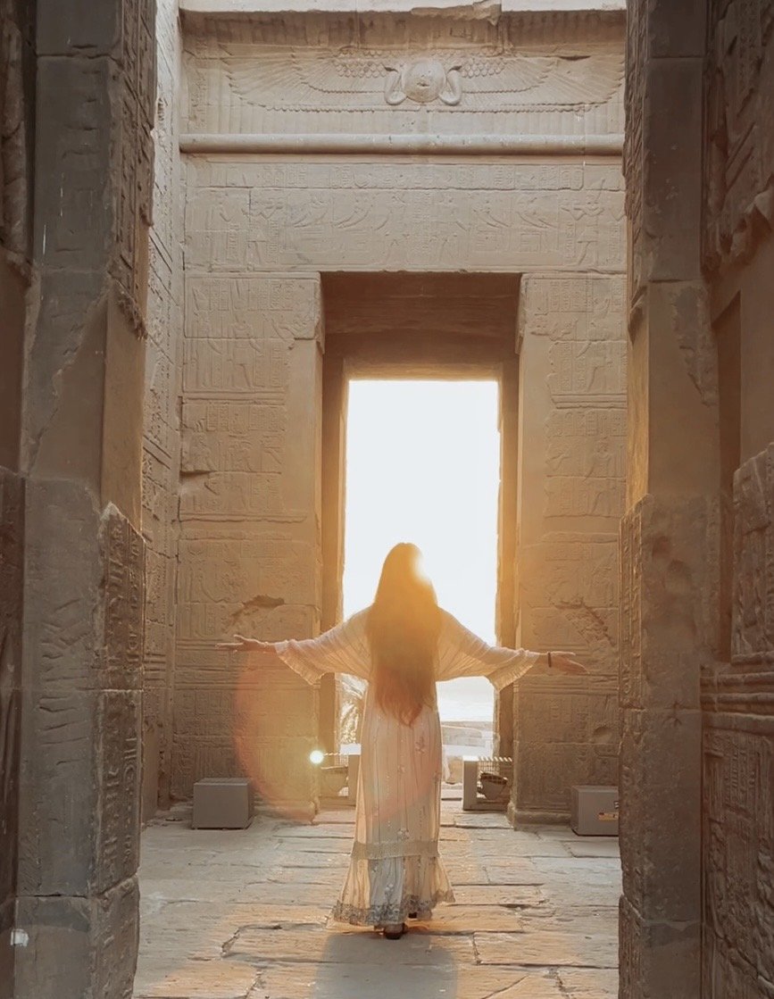 Sabina offering hands-on energy transmission during an Isis–Magdalene Codes Activation at Philae Temple in Egypt — womb healing and sacred feminine ceremony