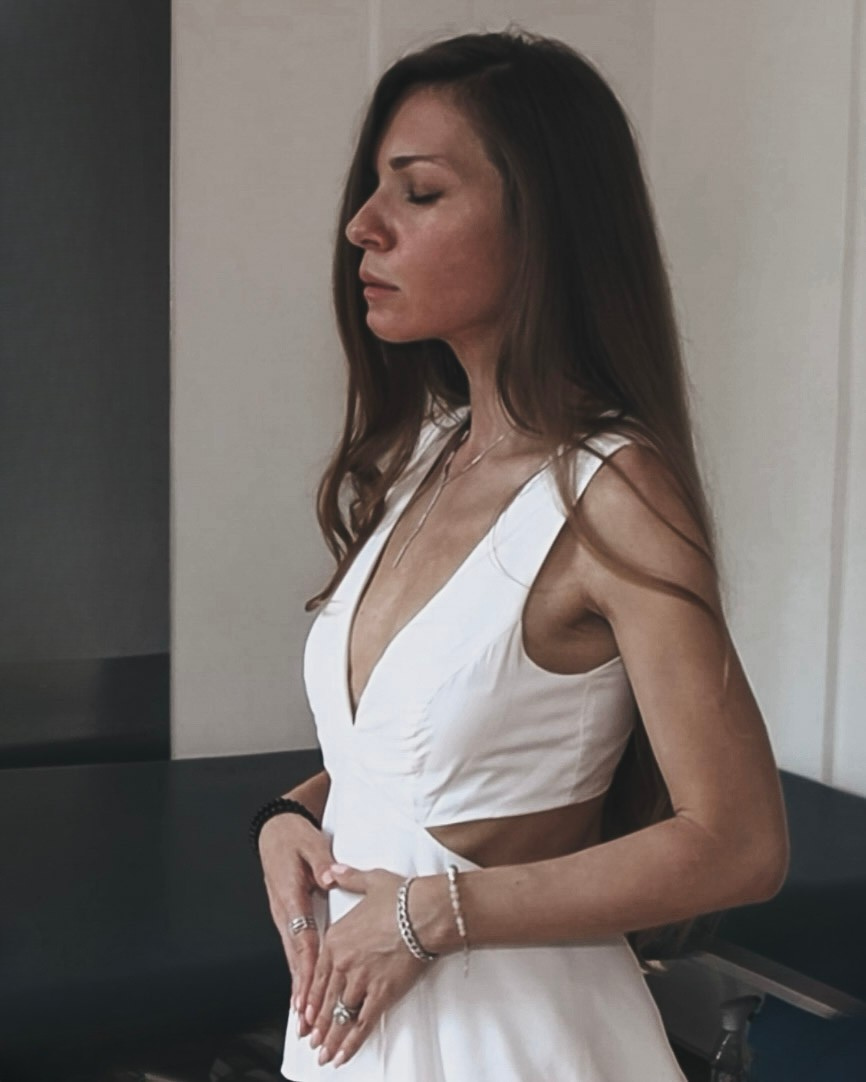 Sabina in sacred presence, holding her womb space during a Magdalene Codes Activation ceremony — a moment of divine feminine remembrance.