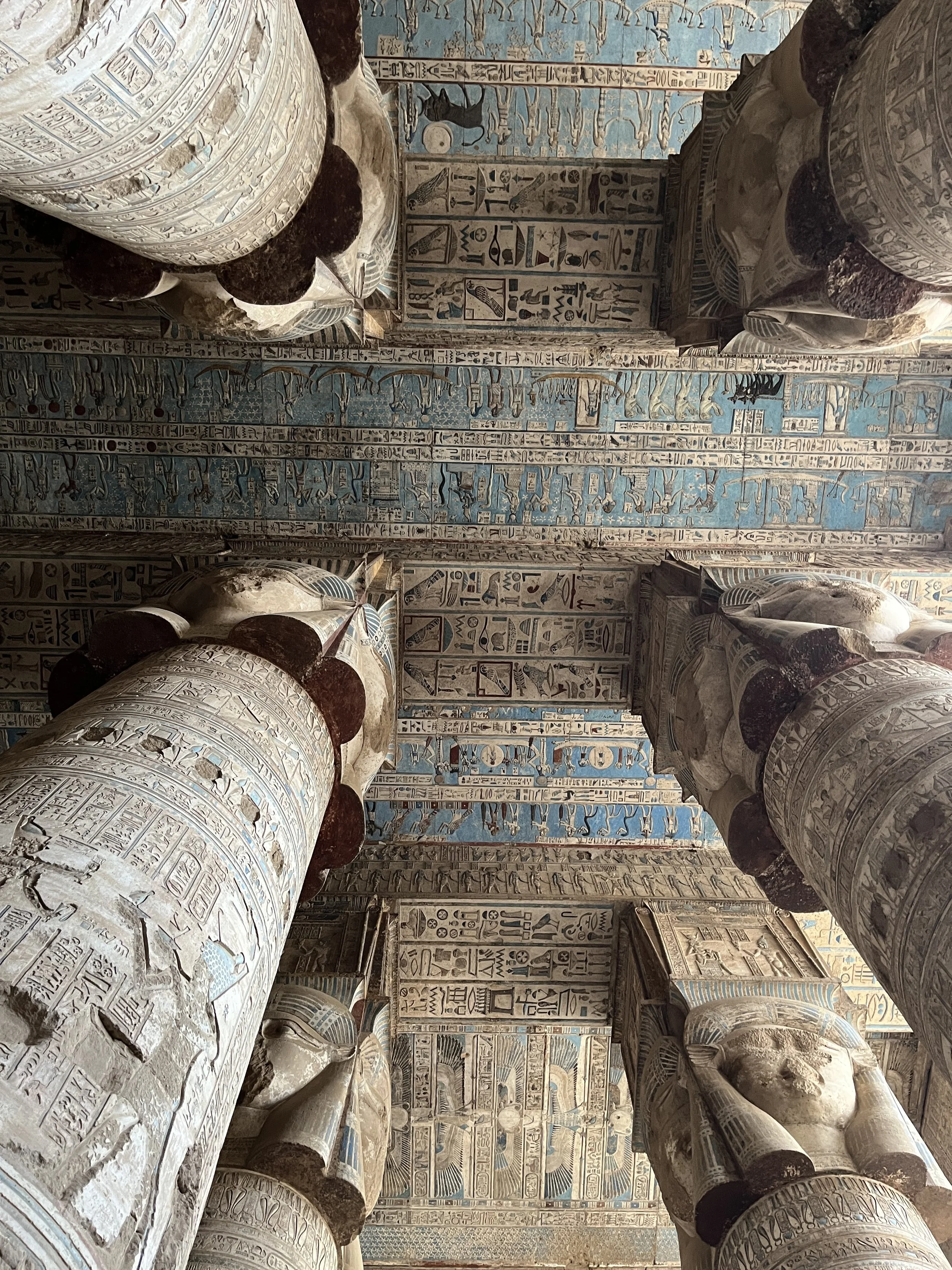 Ancient temple architecture inside Dendera Temple in Egypt featuring detailed hieroglyphs and symbolic artwork connected to spiritual awakening and goddess Hathor.