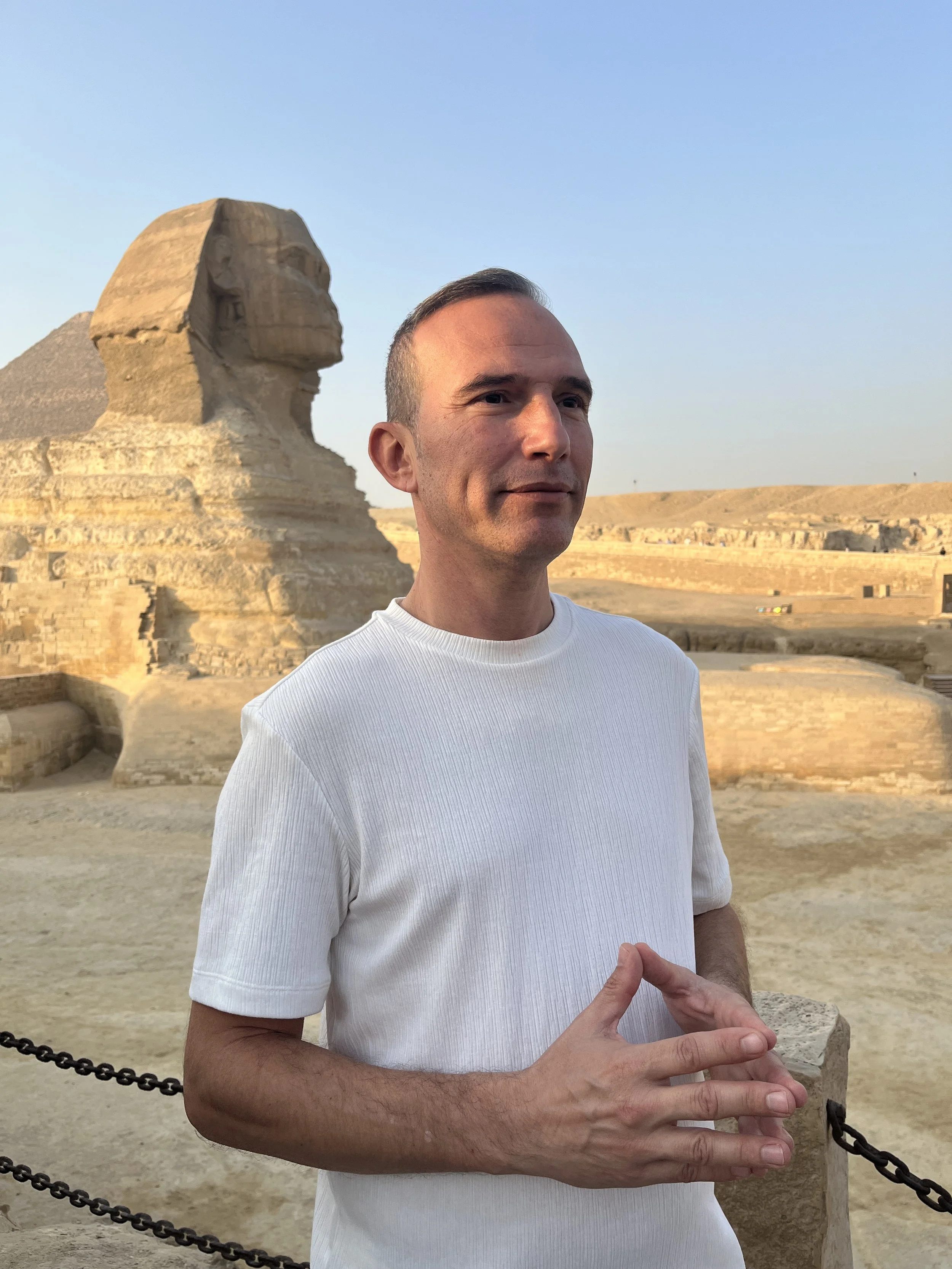 Retreat facilitator at the Sphinx in Egypt guiding a conscious pilgrimage experience.