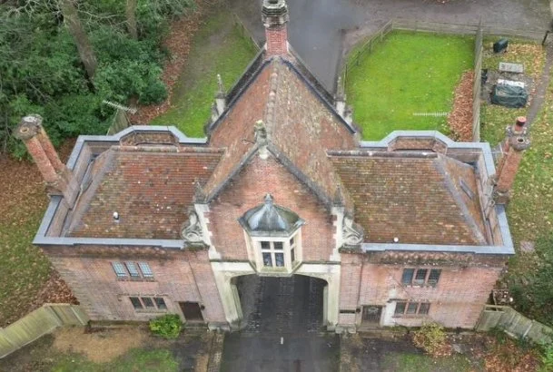Heritage gatehouse with clay tile roofs, aerial view