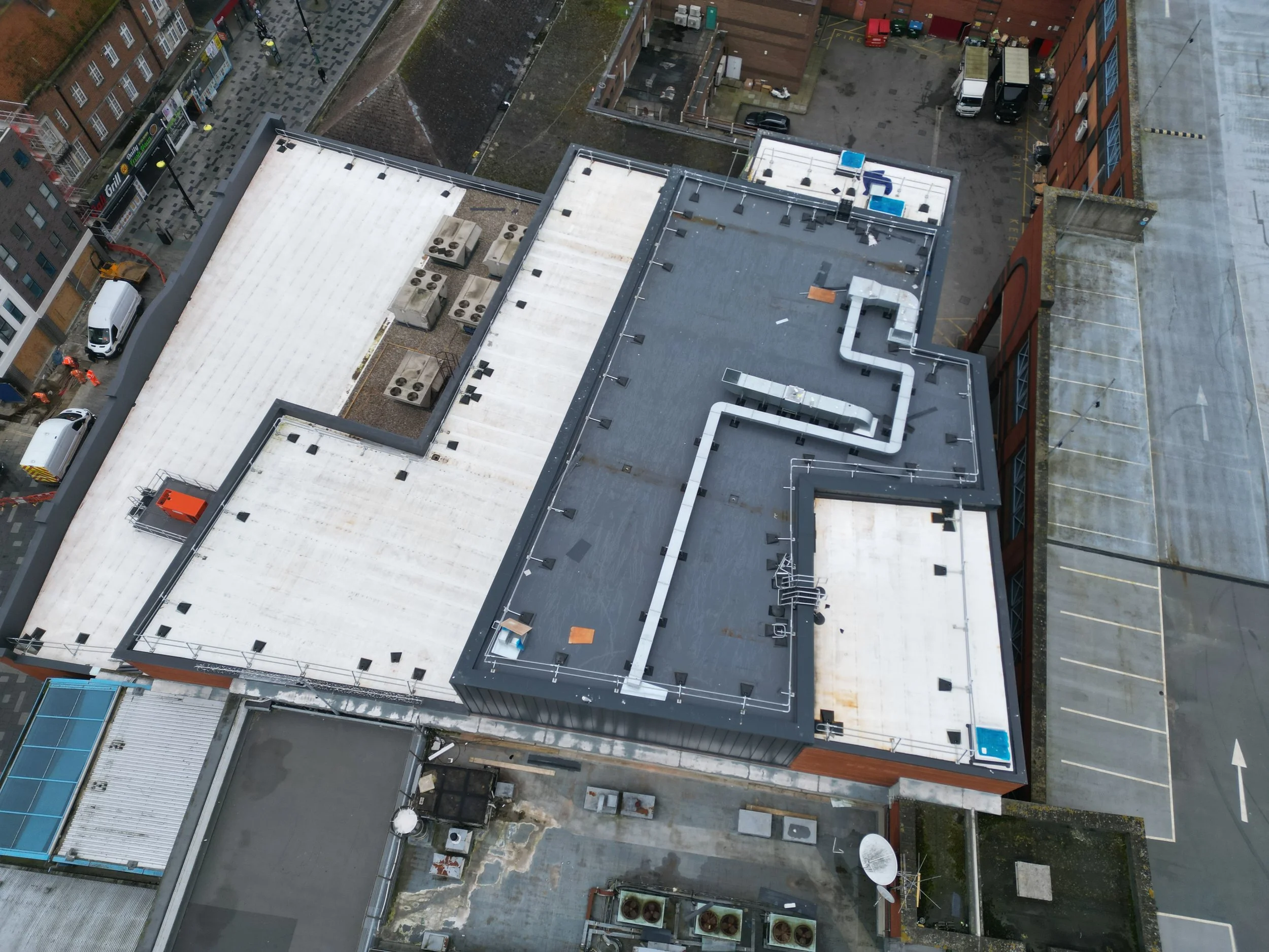 Completed flat roof refurbishment on a commercial building, aerial view