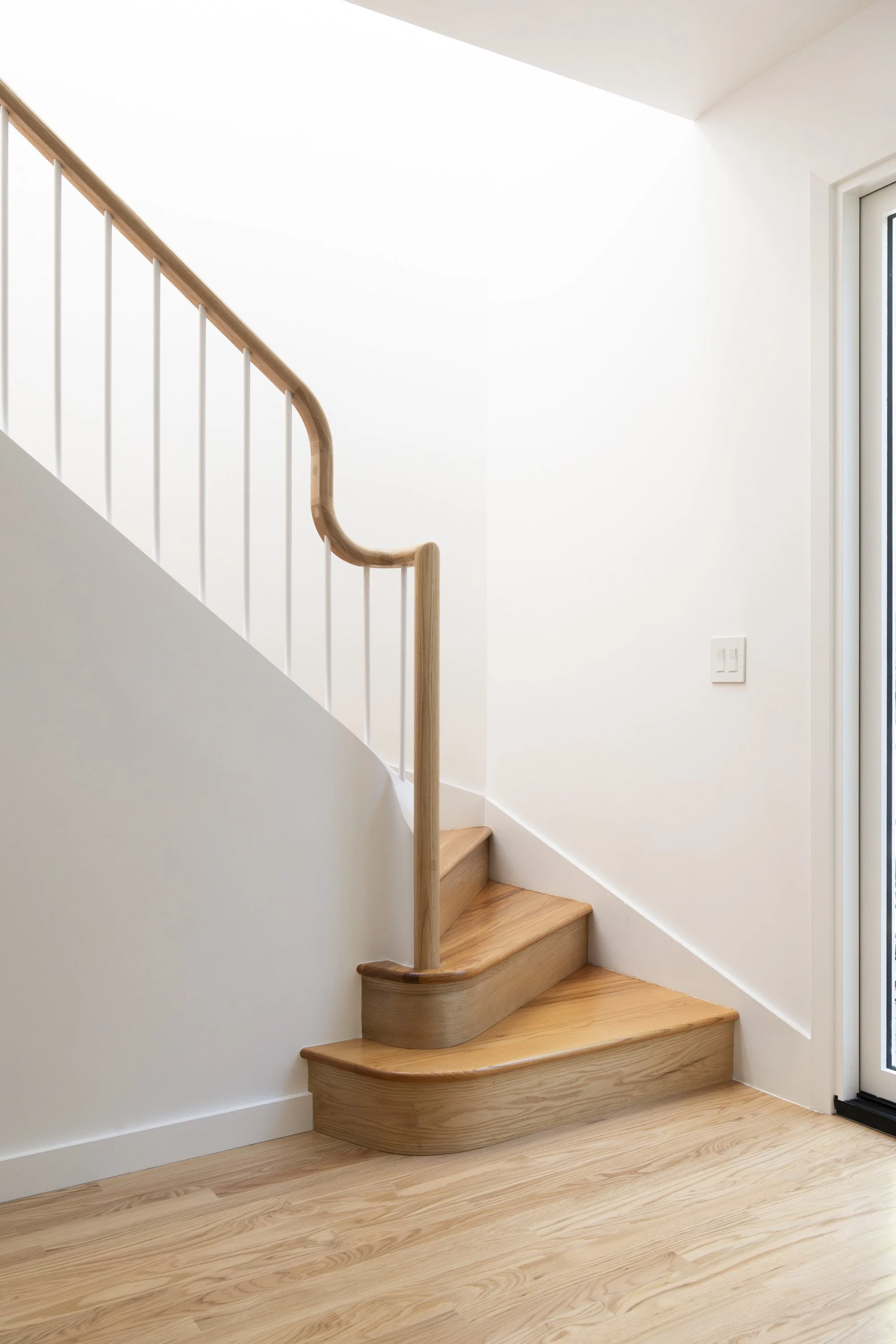 Custom curved staircase with sculptural railings, bringing architectural detail and craftsmanship to this San Francisco home renovation.