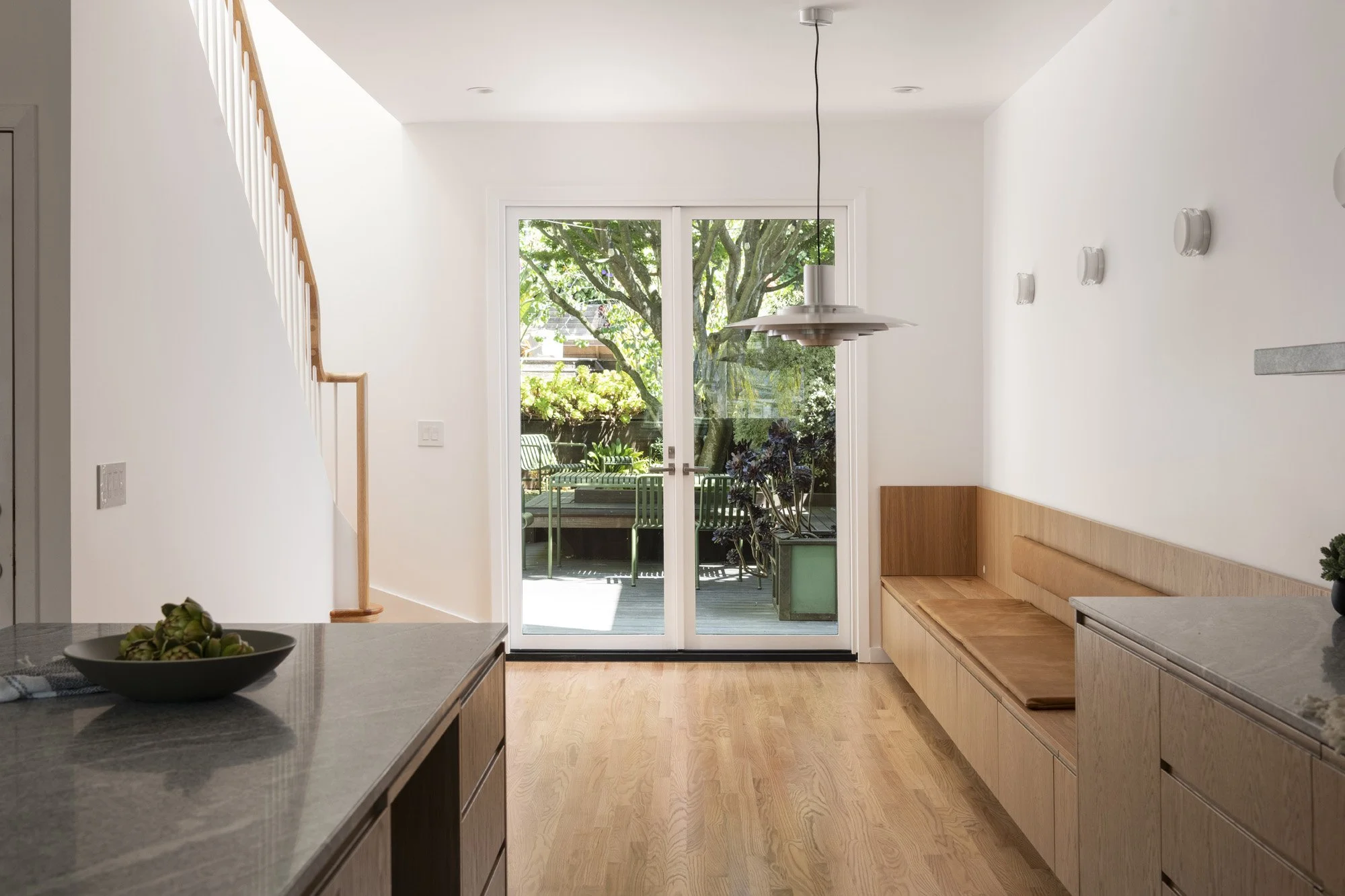 Custom glass doors bring more natural light into this San Francisco renovation while creating a seamless connection between the kitchen and surrounding living spaces.