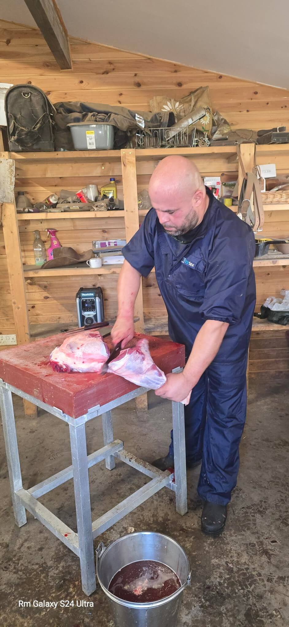 Mobile slaughterman Richard cutting a preparing a leg of lamb