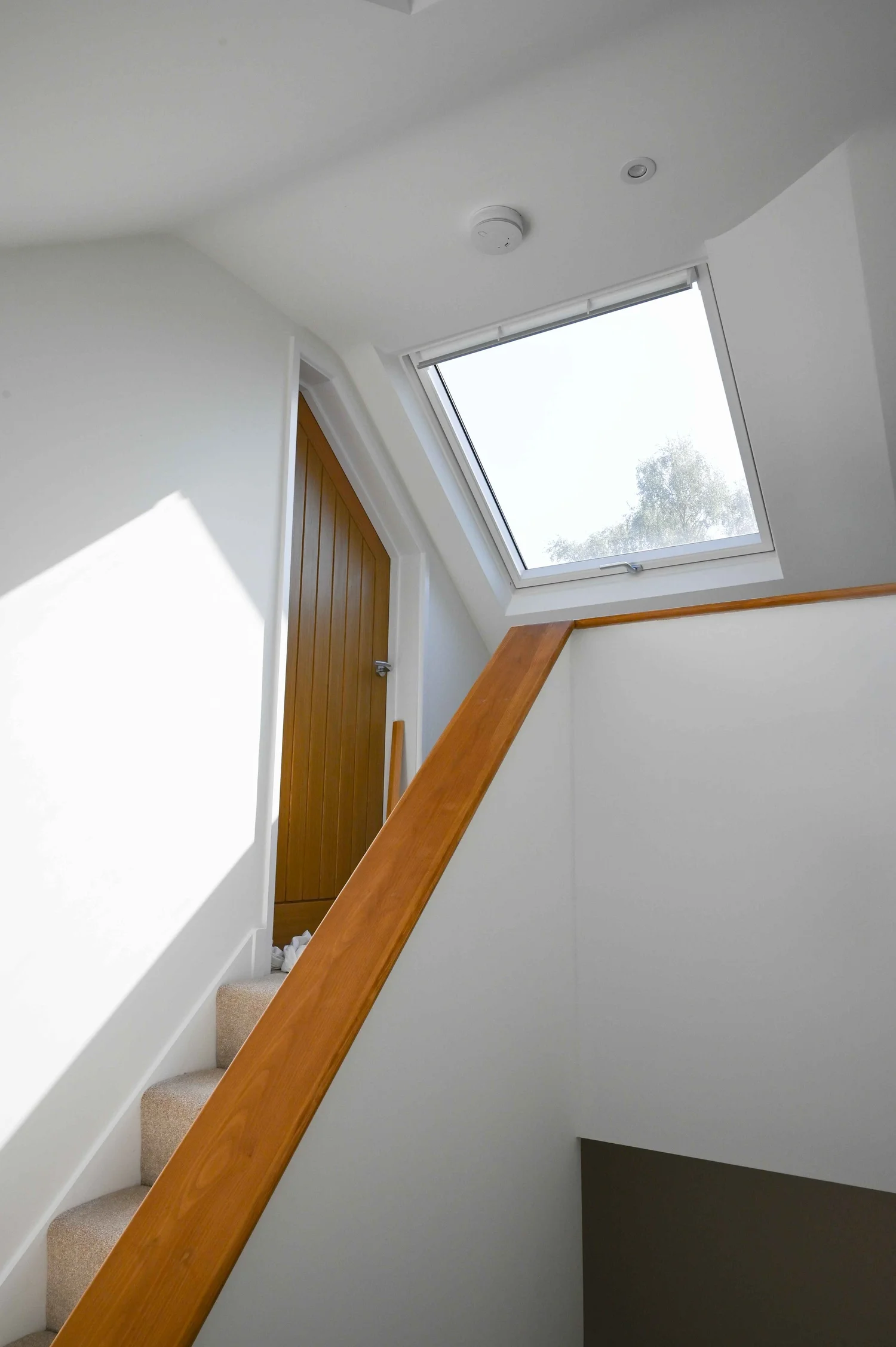Modern staircase and open-plan living space in completed home renovation by RC-Builders Ltd Devon
