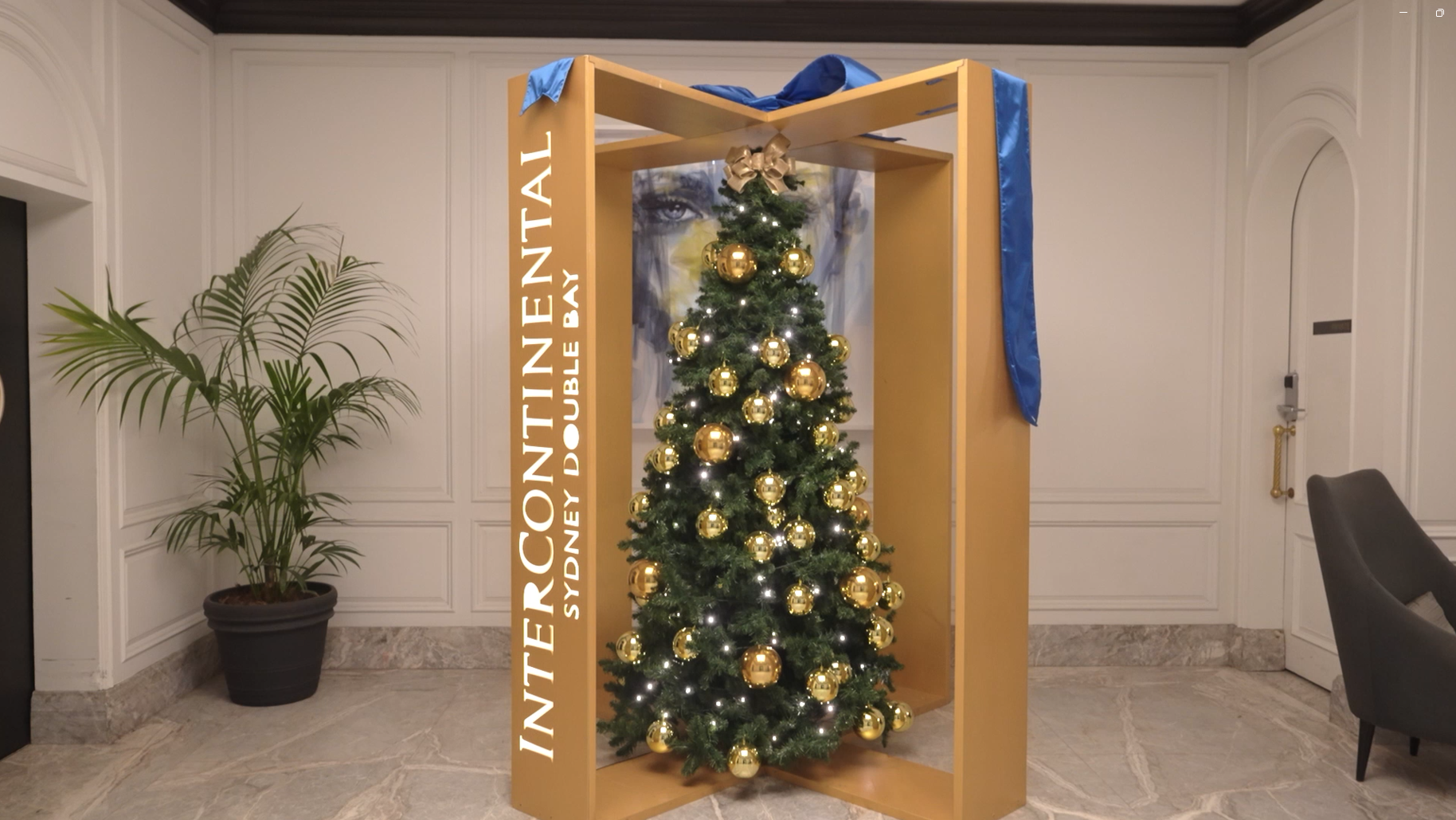 A custom gold-framed festive installation showcasing a perfectly styled indoor Christmas tree alongside minimalist architectural branding for InterContinental Sydney Double Bay.