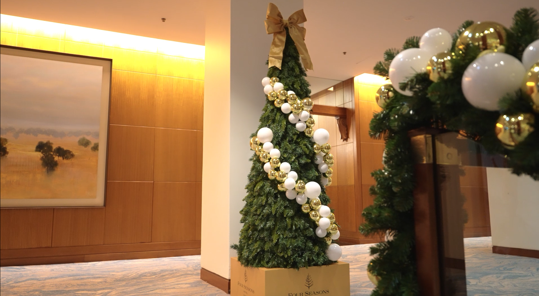 A high-end seasonal tree display showcasing flawless craftsmanship and detailed styling for a prestigious hotel lobby.