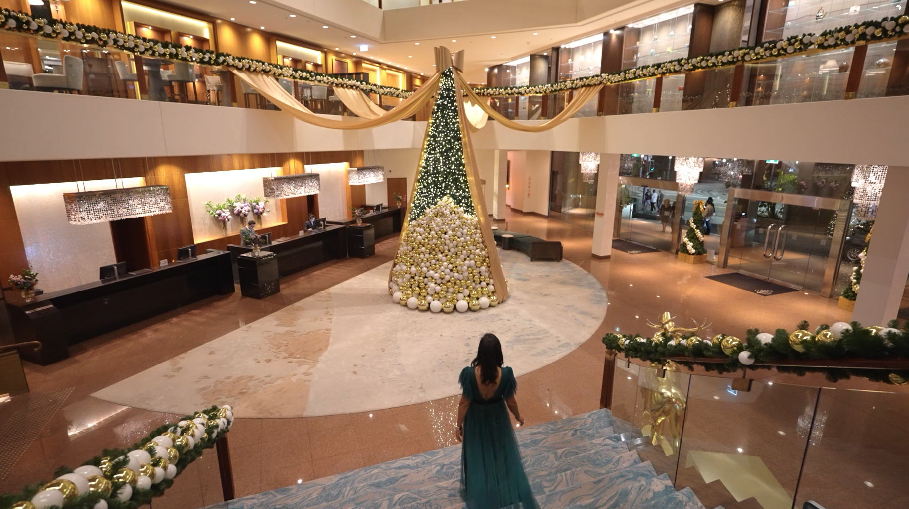 An exquisite holiday installation boasting intricate ornament placement and elite design work for a grand hotel entrance.