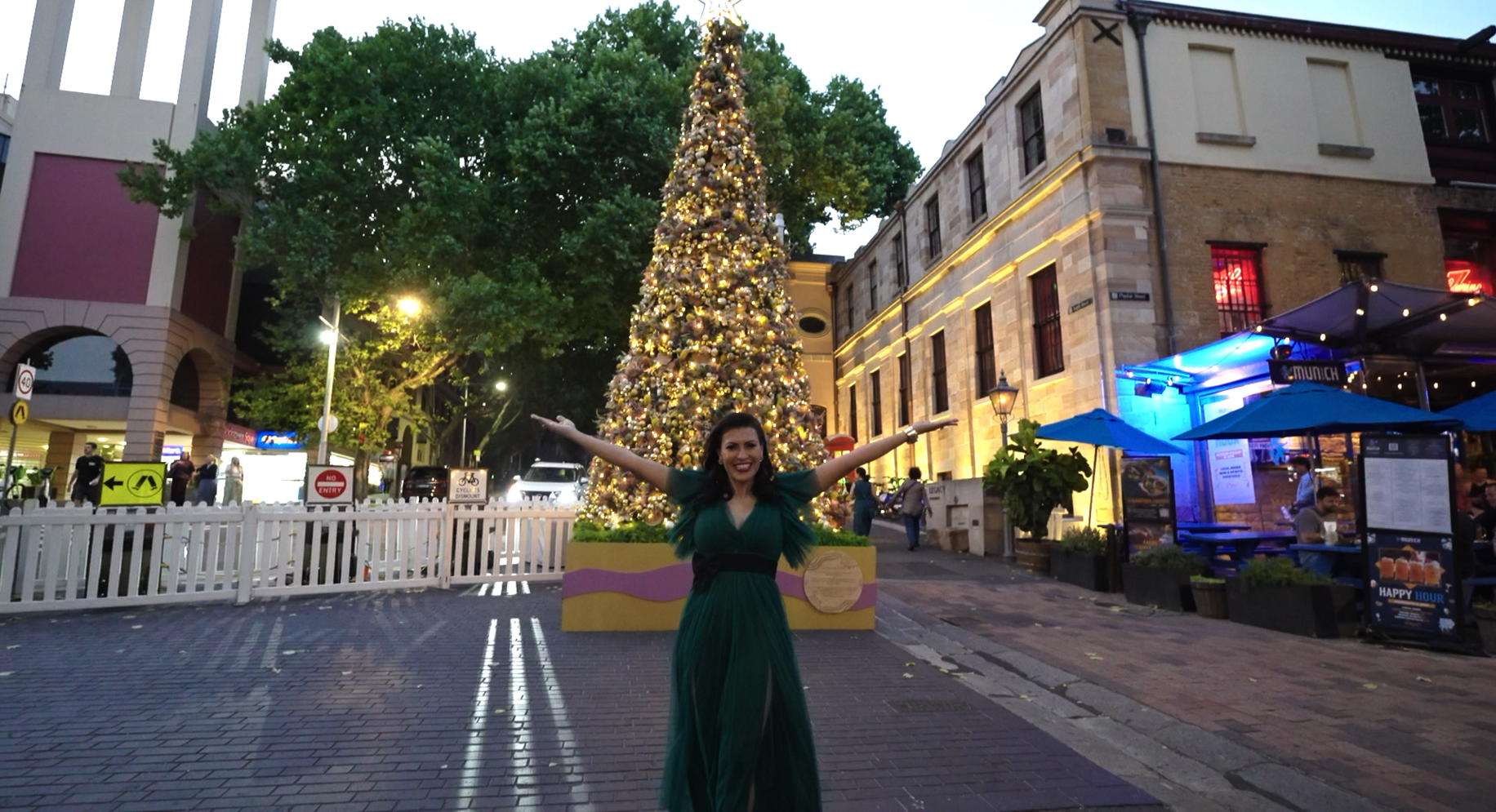 A breathtaking holiday transformation at The Rocks, highlighting an impeccably tailored, gold-draped Christmas tree that commands the promenade as an ultra-luxury, world-class seasonal activation in Australia.