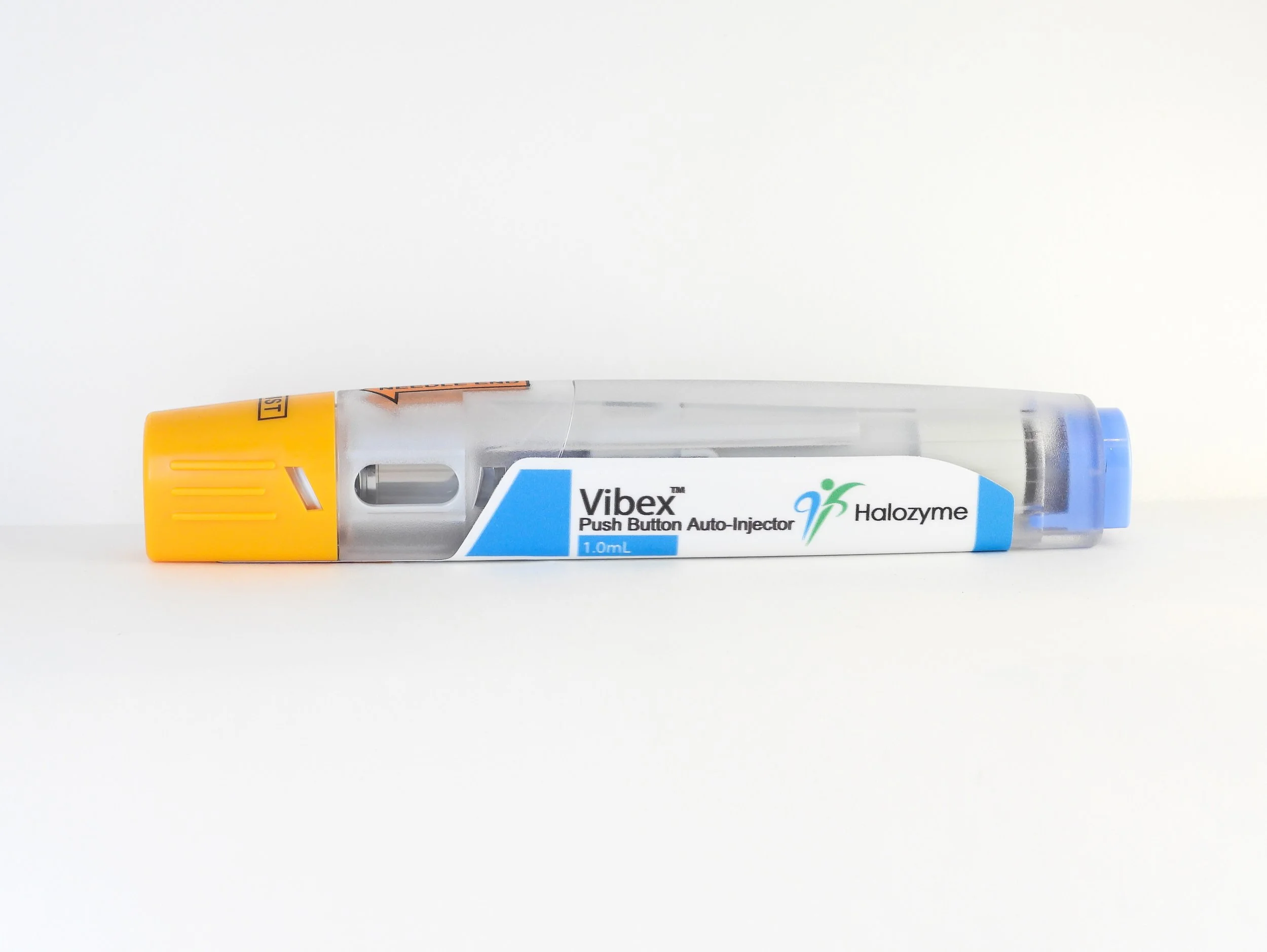A Vibex push button auto-injector with a clear plastic body, yellow safety cap, and blue end cap, labeled with its brand, dosage, and purpose.