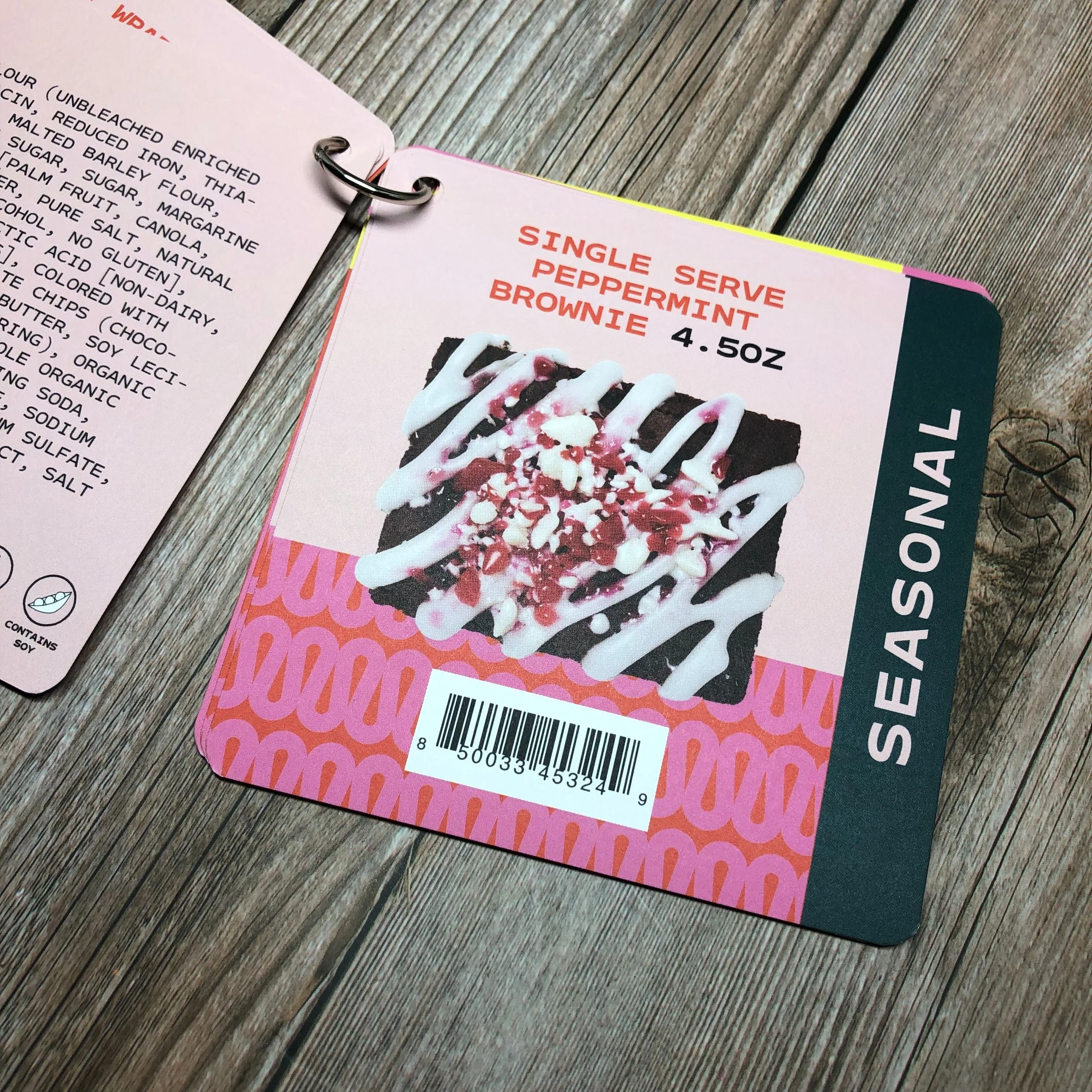 Menu card displaying a single serve peppermint brownie with white icing, peppermint pieces, and chocolate drizzle, priced at 4.5 ounces.