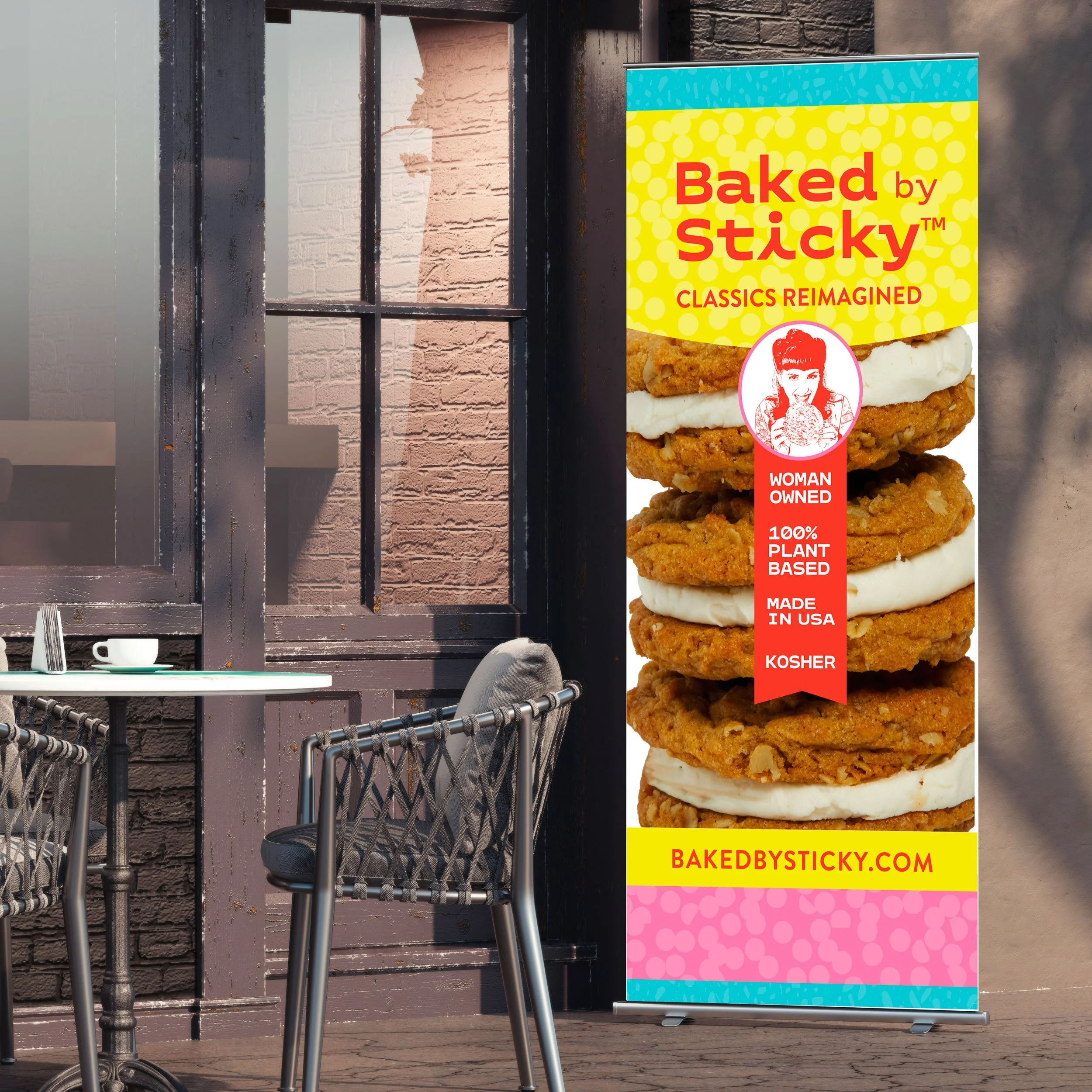 A colorful outdoor banner advertising cookies from Baked by Sticky, featuring a close-up image of a cookie sandwich with white filling, and information that the company is woman owned, 100% plant based, made in the USA, and kosher.