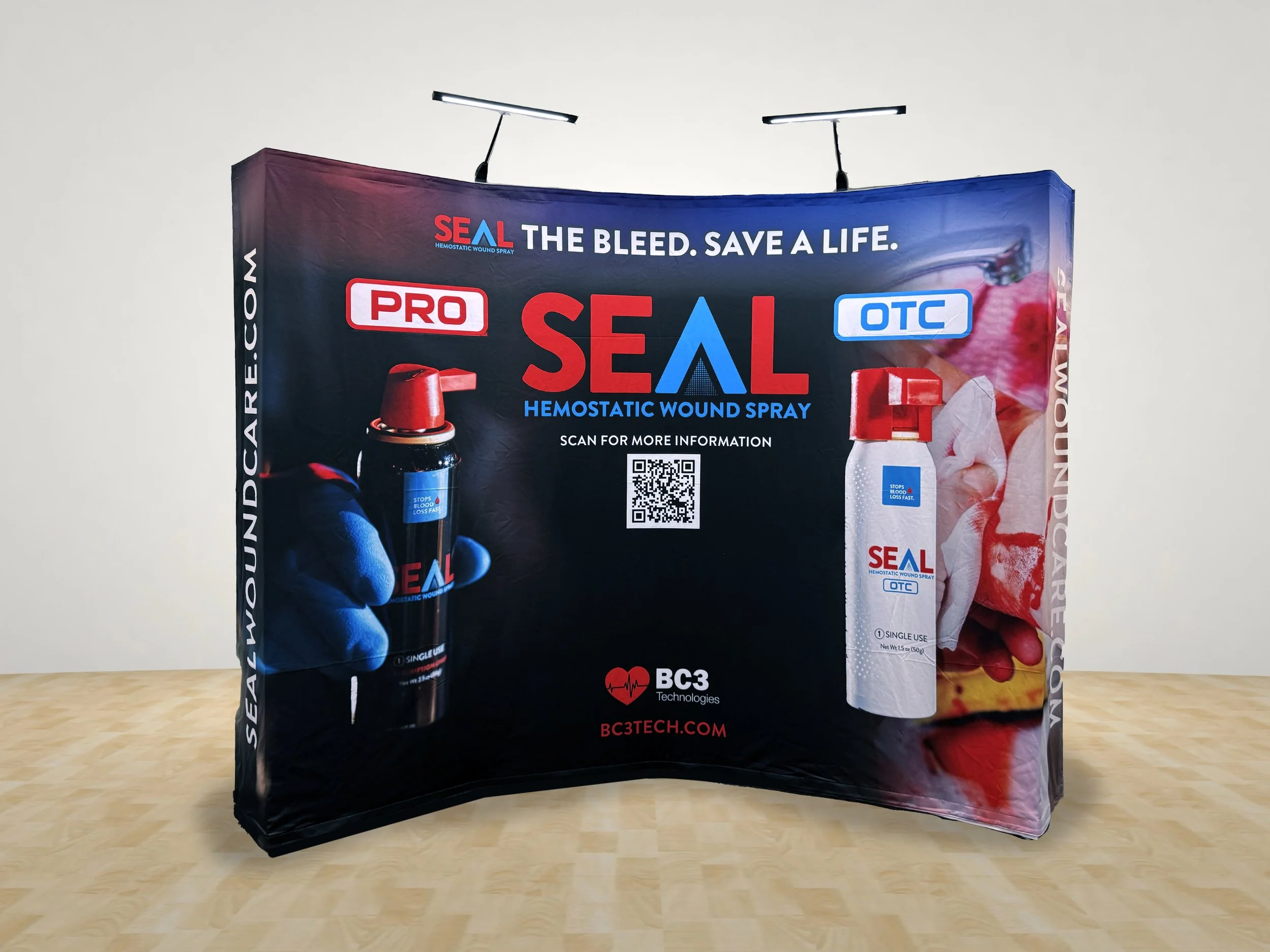 A promotional display for SEAL hemostatic wound spray, showing two bottles of the product, one labeled 'PRO' and the other 'OTC,' with a QR code for more information, and branding including BC3 Technologies and the website BC3TECH.COM.