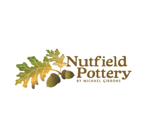 Logo for Nutfield Pottery with an oak leaf and acorns