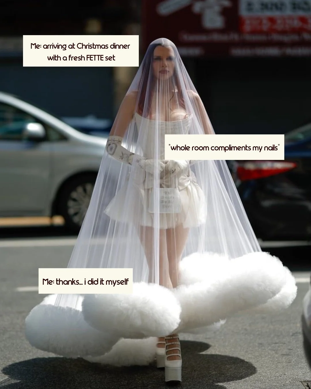 A person in a white, avant-garde outfit with a sheer veil and platform shoes, walking on a street. The outfit includes fluffy, cloud-like elements near the feet. Text overlays read humorous captions about arriving at Christmas dinner.