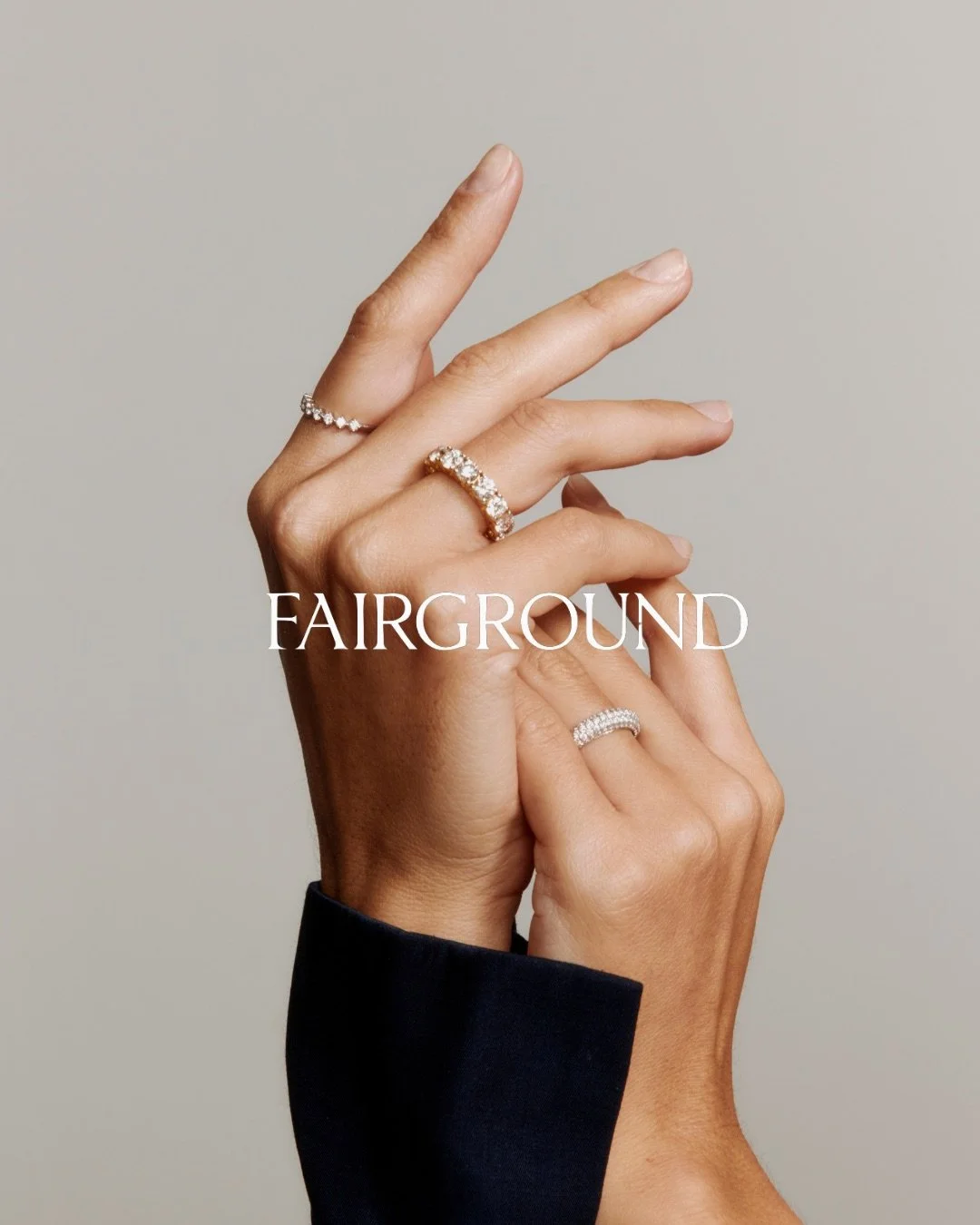 Hands with rings displaying jewelry, text "Fairground" overlaid.