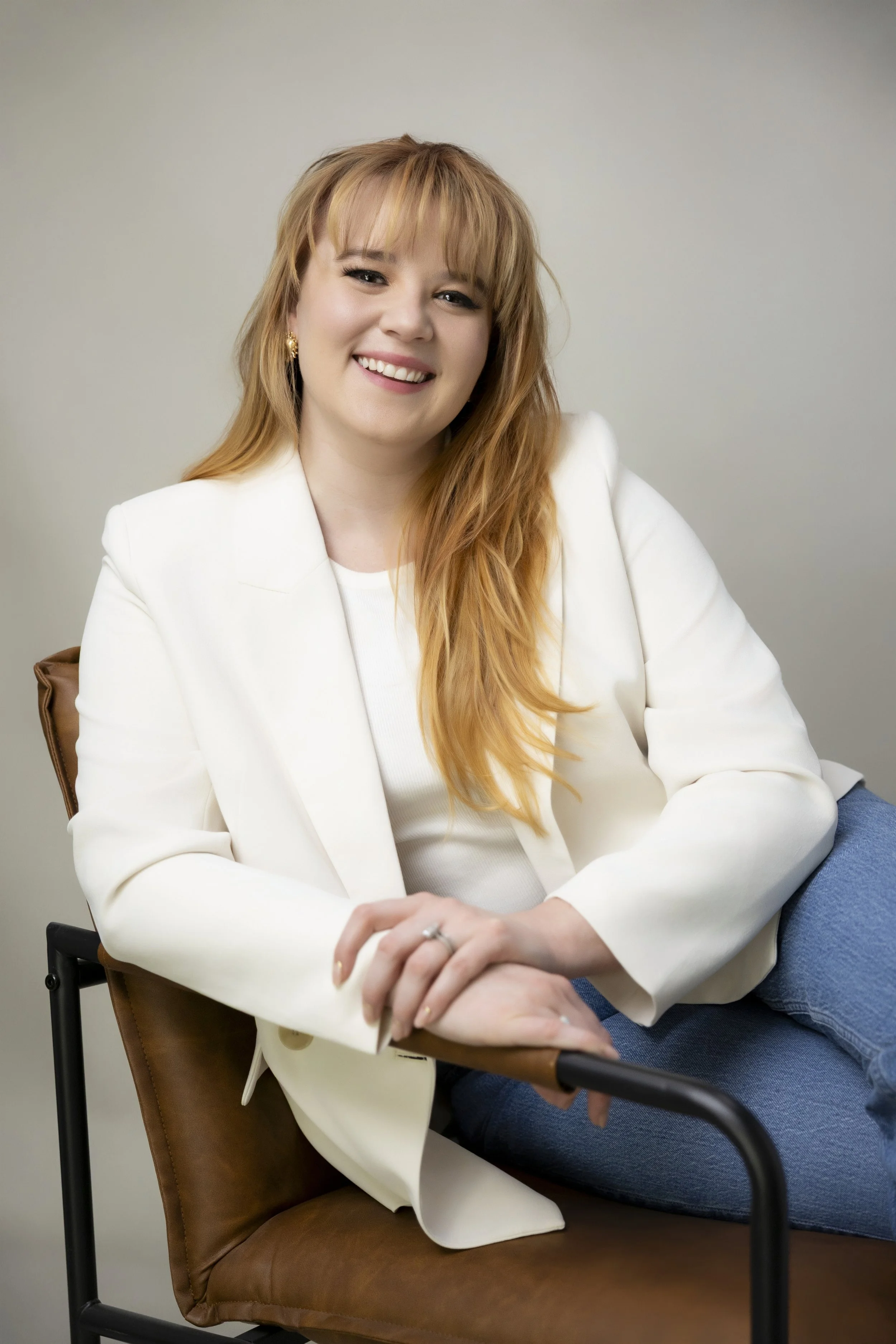 Contact a smiling woman therapist sitting in brown chair, offering in-person and online therapy in Mill Valley California