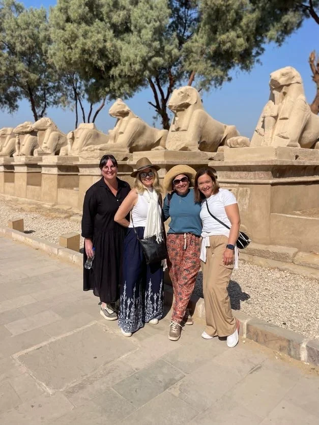 The group walking among ancient sphinx statues at Karnak
