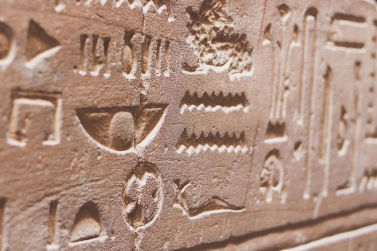 A wall of hieroglyphics carved into ancient temple stone
