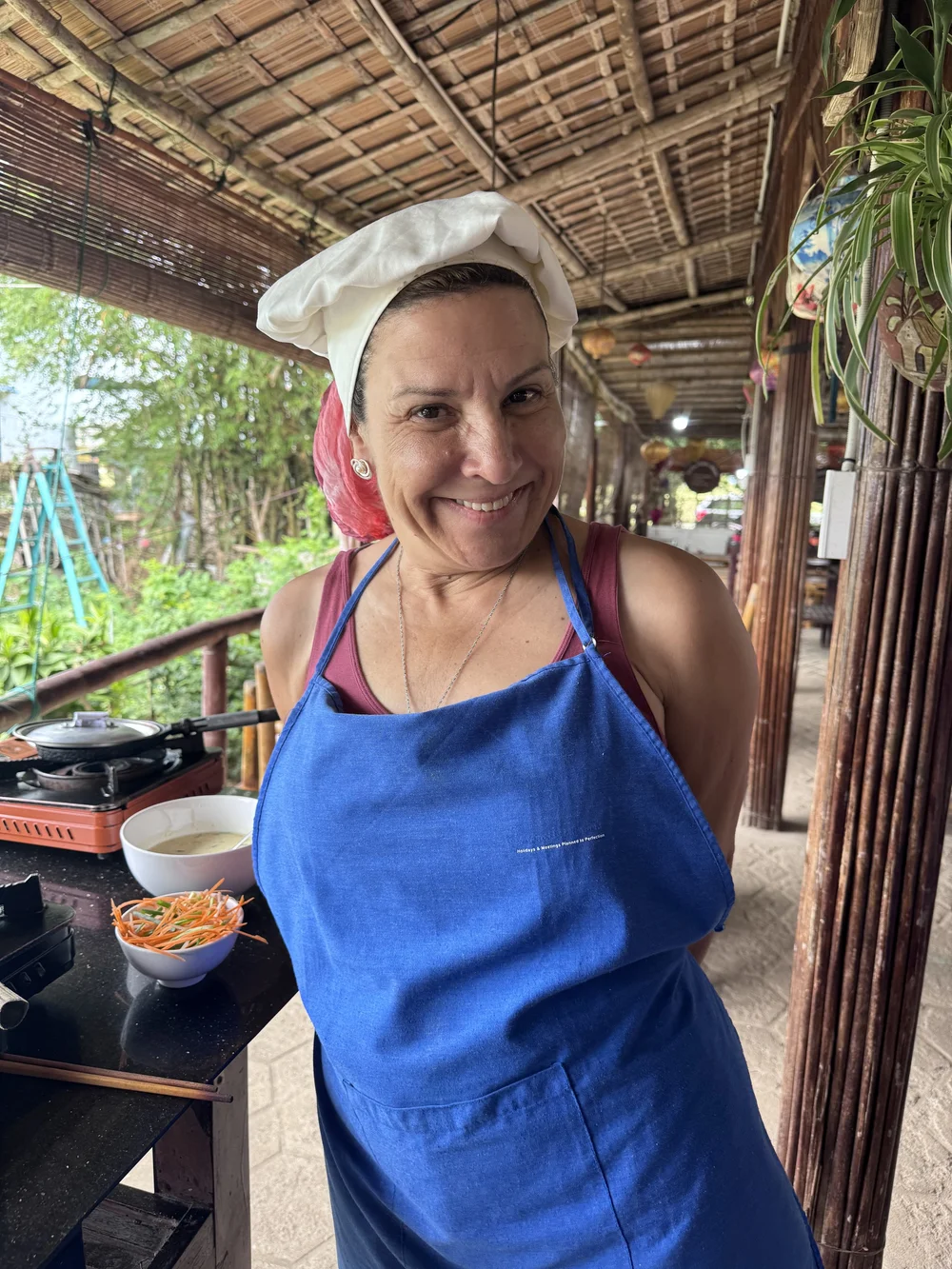 A traveler in a chef's hat and apron during the Hoi An cooking class