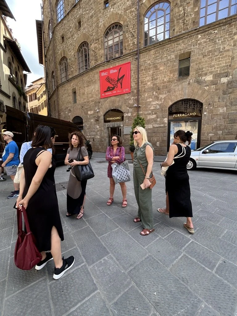 The group strolling past boutiques on a Florence street