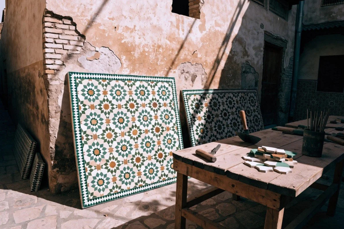 Zellige tile mosaic panels and hand tools in a Fes artisan workshop