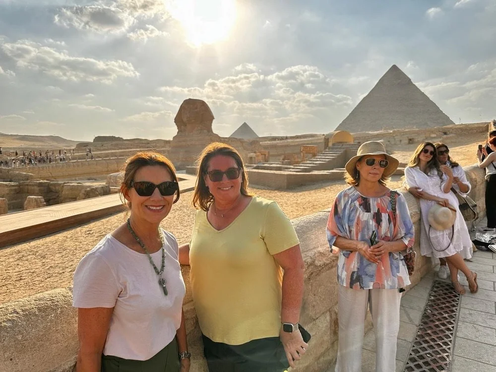 Dandelion Journals travelers together in front of the Great Sphinx and the Pyramids of Giza