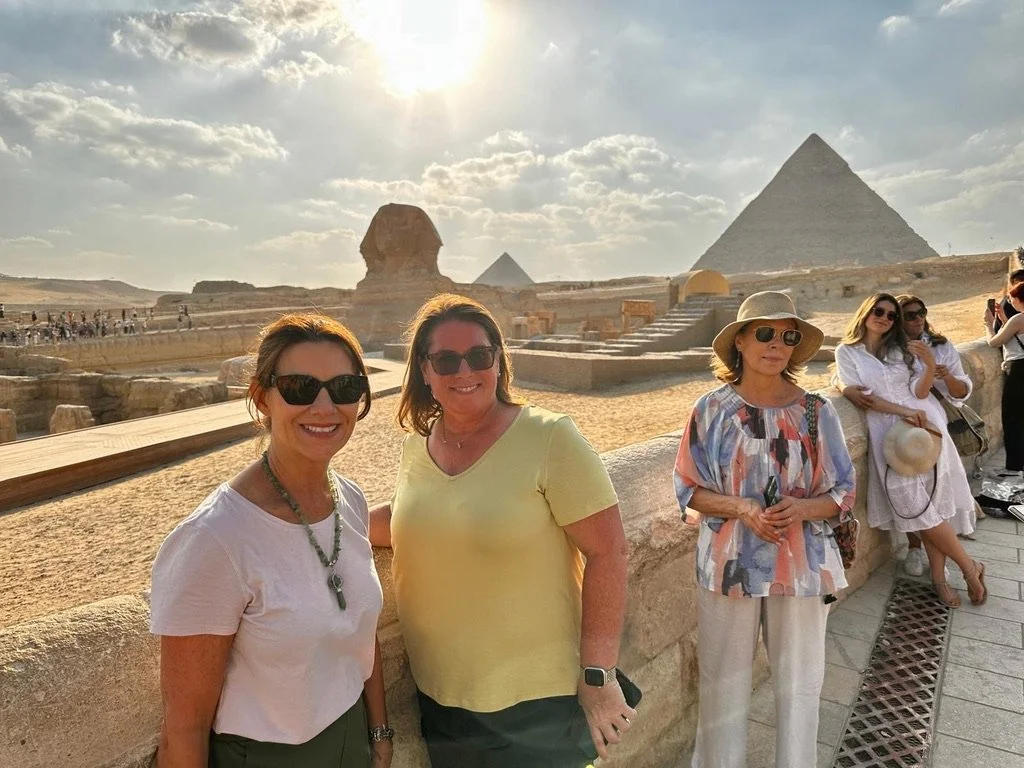 Dandelion travelers taking a selfie in front of the Great Sphinx and pyramid at Giza