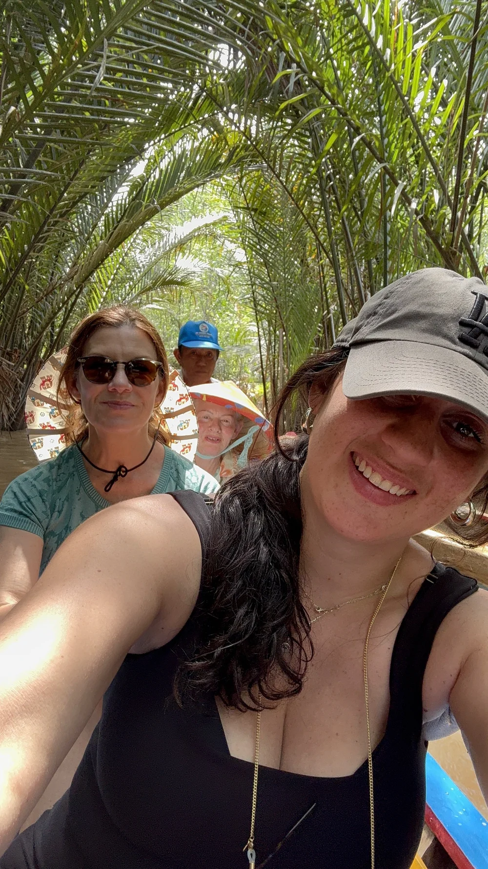Four travelers together on a deck with the water behind them