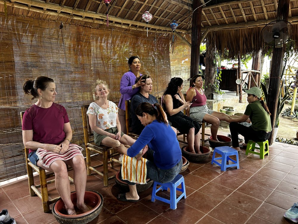 The group having foot baths at a rustic open-air spa