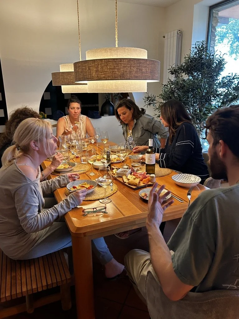 Dandelion travelers sharing a chef-prepared dinner around the villa table