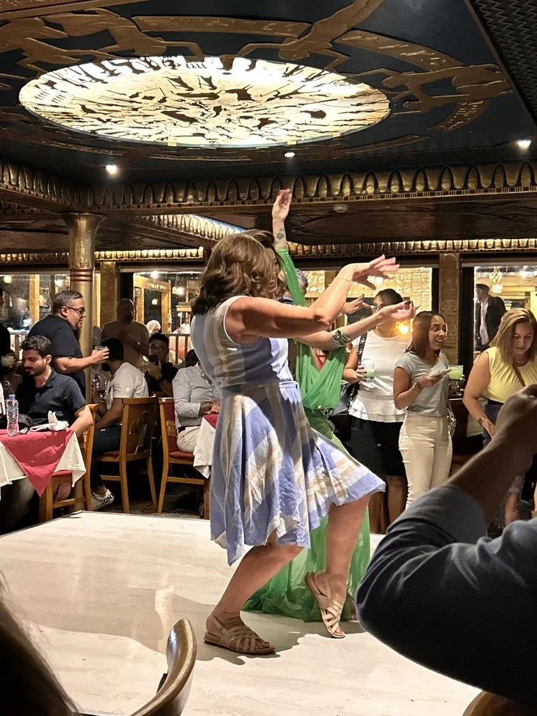 The group celebrating at a lively Egyptian dinner