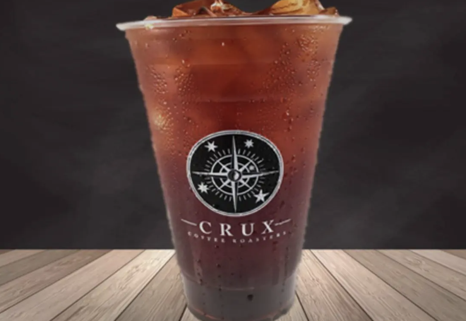 Plastic cup filled with iced coffee from Crux Coffee Roasters.