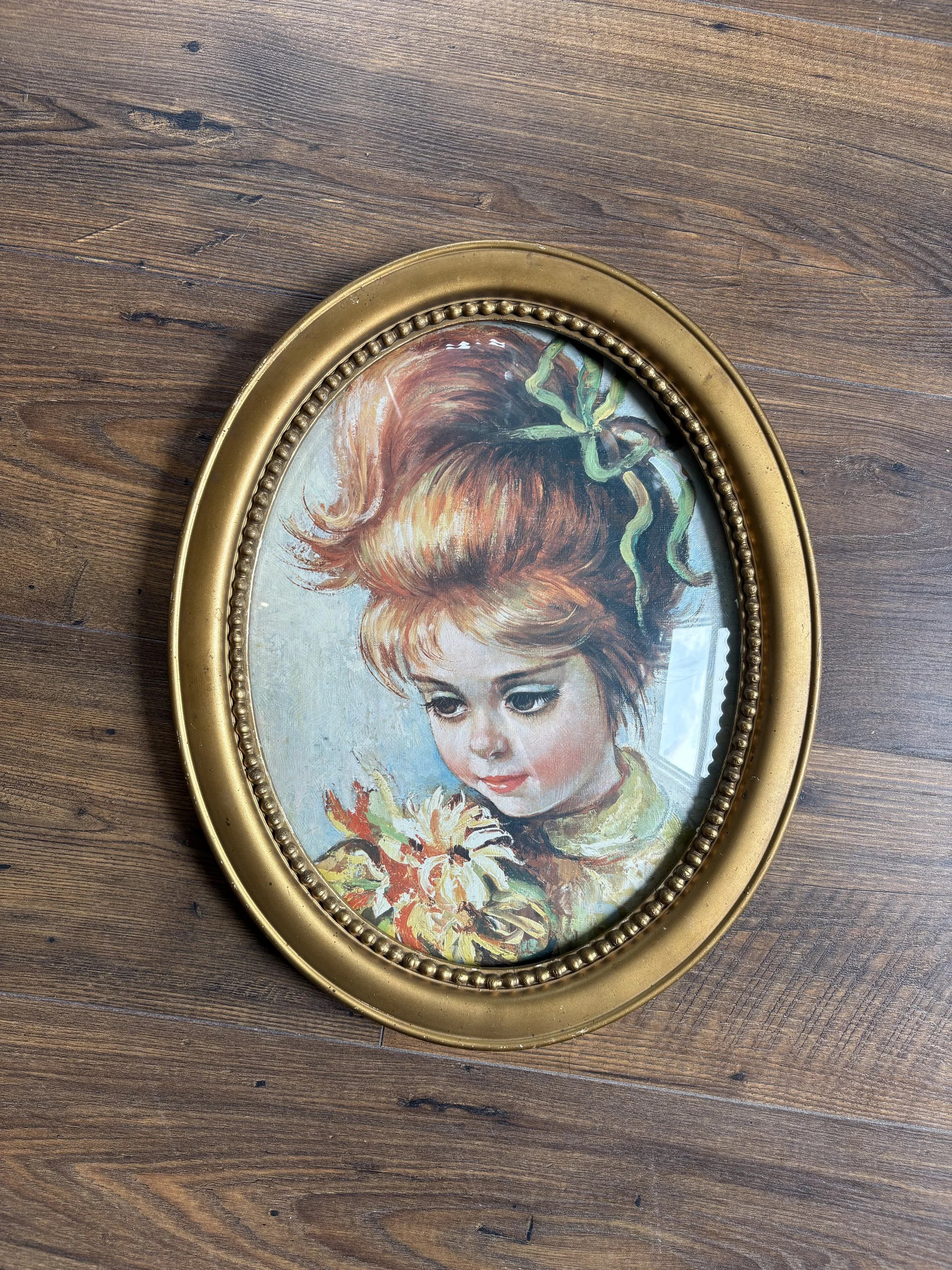 13”x10” gold oval frame with convex glass