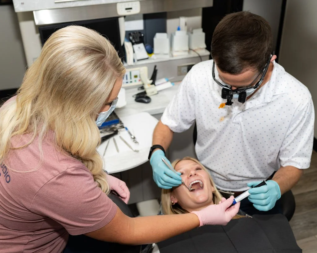 Dentist and dental assistance providing dental treatment to patient