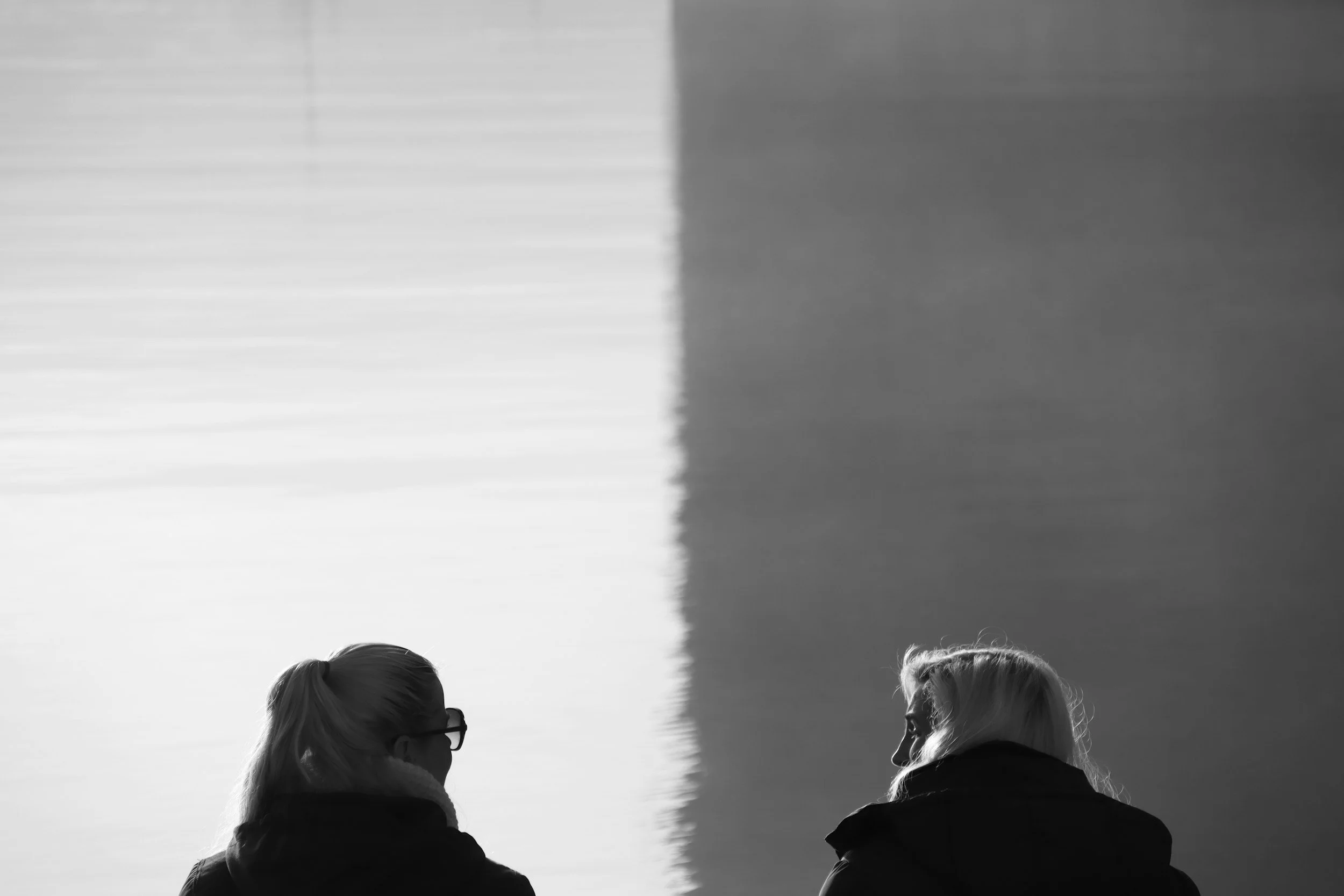 Two people talking with a sky backdrop