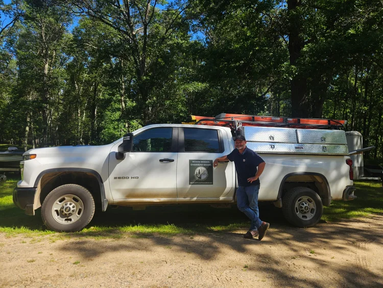 North Woods Overhead Doors service truck with Jon on-site — we come to you for installs and repairs across Northern Minnesota.