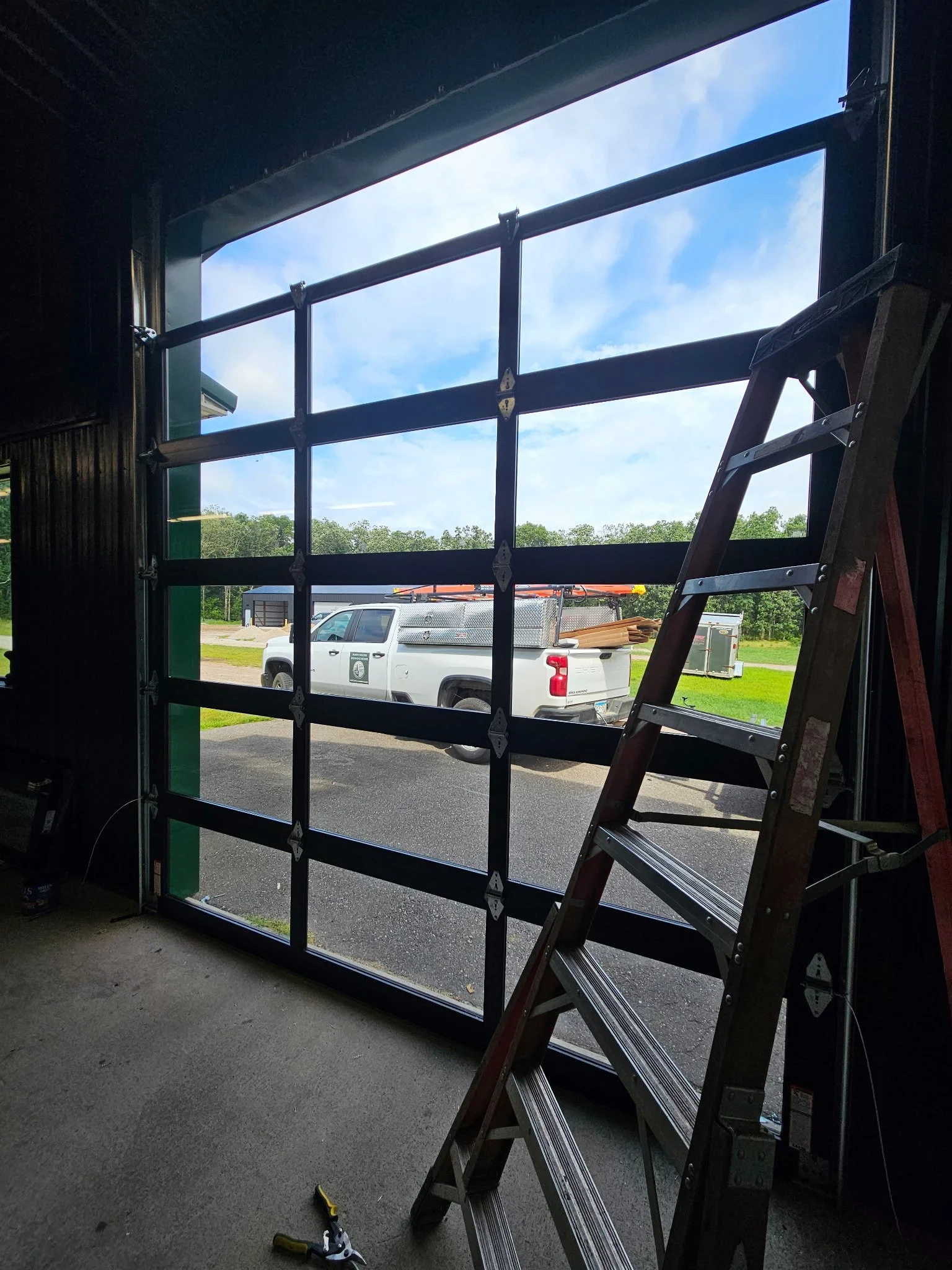 Wayne Dalton commercial full-view garage door with windows installed by North Woods Overhead Doors in Northern Minnesota β modern design, durable aluminum frame, and energy-efficient glass.
