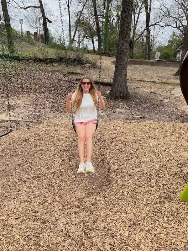 Becca Morris, Counselor and Reiki Master, in Augusta, GA, letting her inner child out to play on a swing.