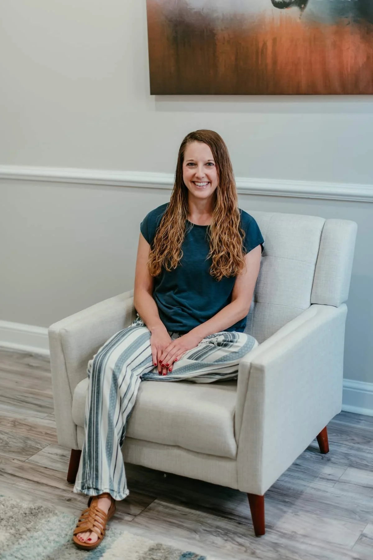 Becca Morris, Counselor at Inspired Light Counseling, sitting in her therapy chair creating a calm, welcoming space for clients in Augusta, GA.