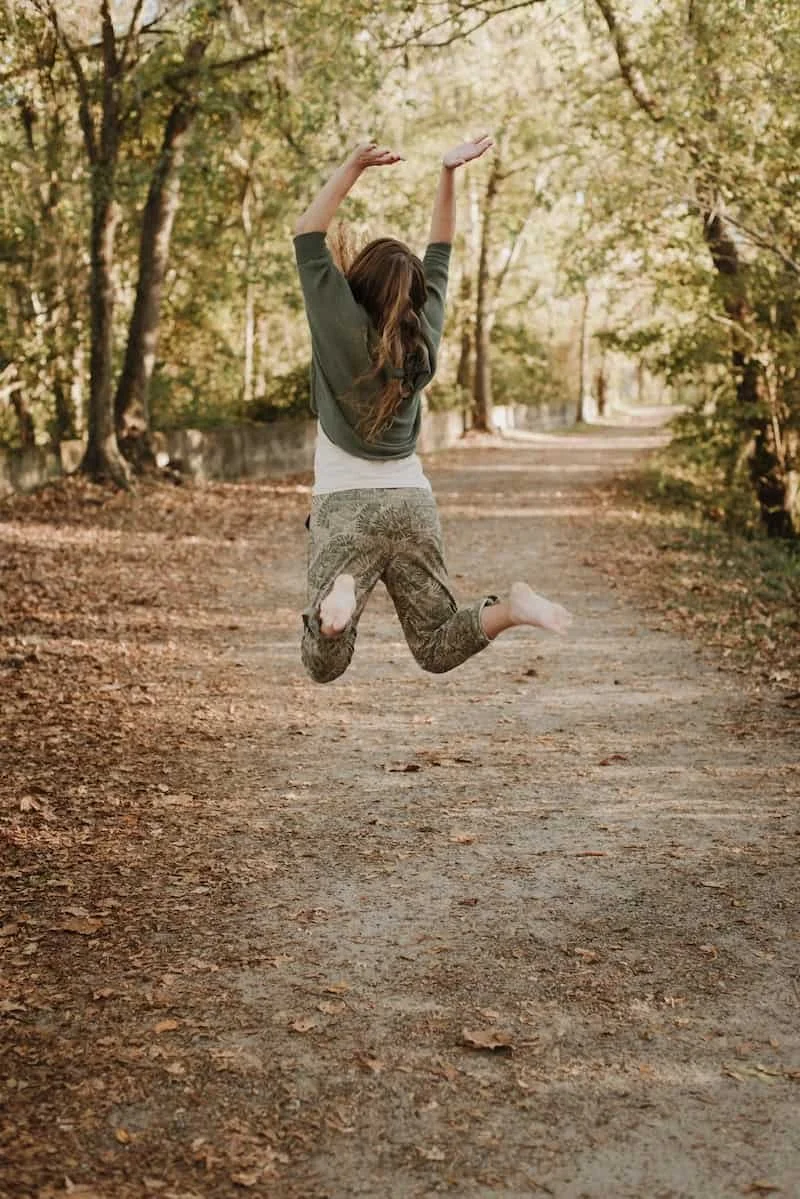 Becca Morris, Counselor and Reiki Master, jumping in the air showing energy and excitement for her work in Augusta, GA.