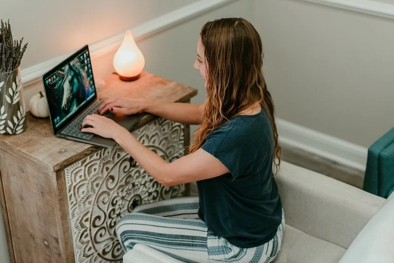 Becca Morris, Therapist and Reiki Master, focused on her work at a laptop, preparing sessions for clients in Augusta, GA.