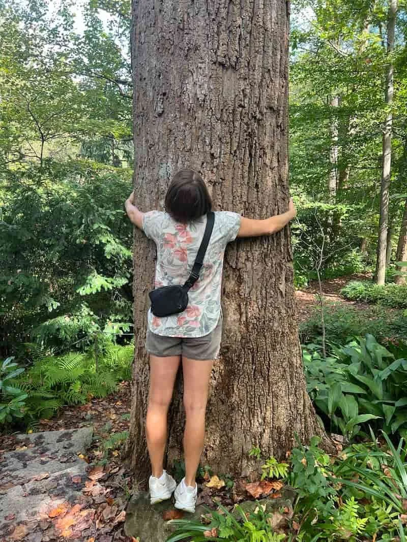Becca Morris, Reiki Practioner in Augusta, GA, hugging a tree to clear her energy field.
