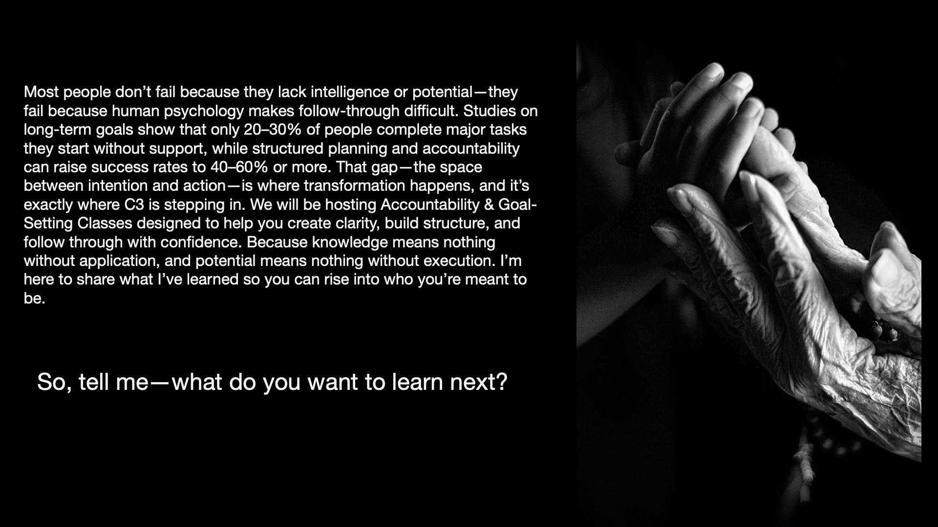 Black and white photograph of two hands, one older with visible wrinkles, clasped gently.